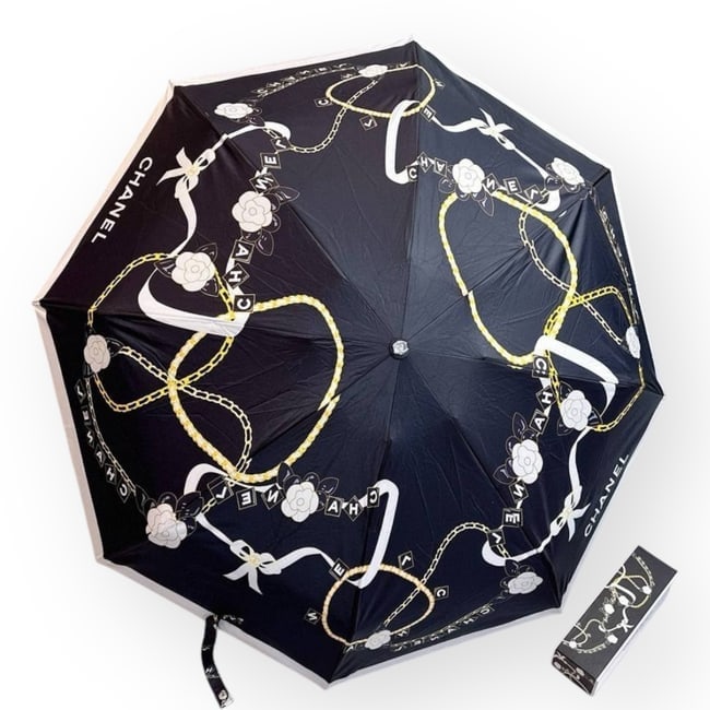 CHANEL Black/White Belt Decor Beaute Umbrella, Sleeve, & Box: • CHANEL • Umbrella • Black • White & Gold Accents • Belt Decorated • Original Storage Sleeve Included • Original Box Included • Handle Loop For Easy Carry &bul
