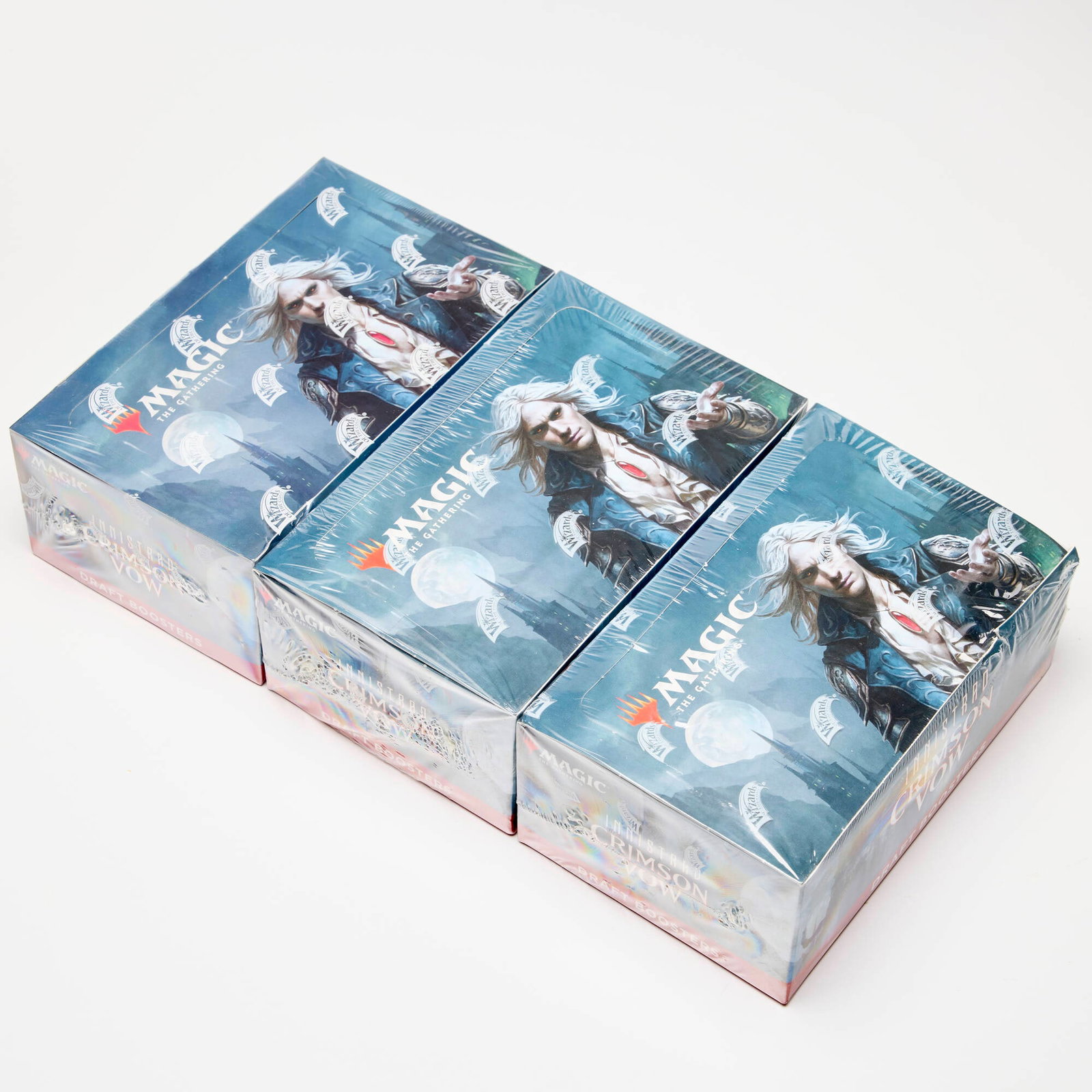 Three 2021 Magic: The Gathering Innistrad Crimson Vow Booster Box Factory Sealed: Three 2021 Magic: The Gathering Innistrad Crimson Vow Booster Box Factory Sealed USA, 2021 All factory sealed within tight and intact Wizards of the Coast branded cellophane wrap, one with crush to bo