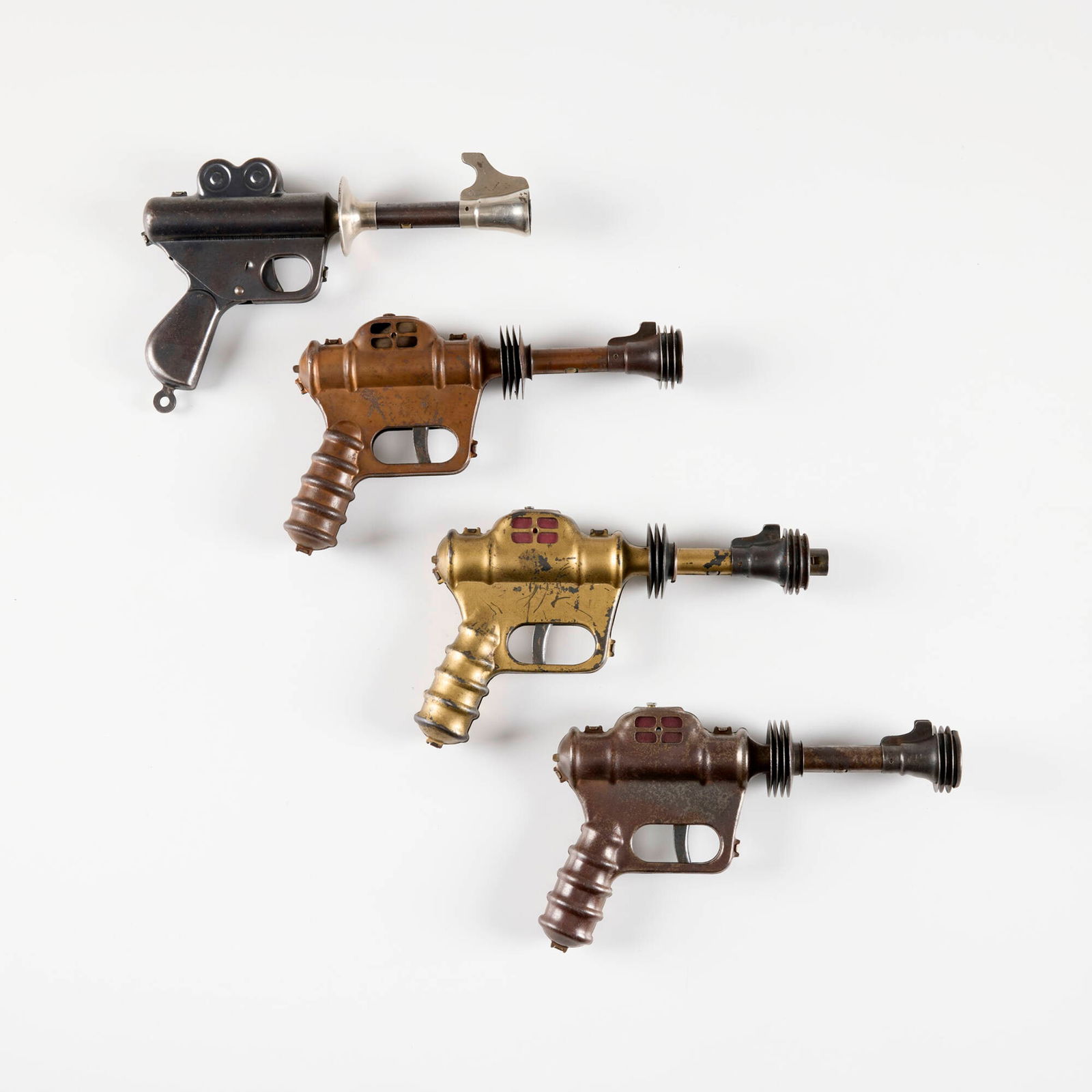 Four Daisy Buck Rogers Atomic Pistol Ray Guns: Four Daisy Buck Rogers Atomic Pistol Ray Guns lacquered, patinated, and nickle-plated metal 5.75 h x 10 w x 1.875 d in (15 x 25 x 5 cm) Impressed manufacturer's mark to handle of each example 'Buck Ro
