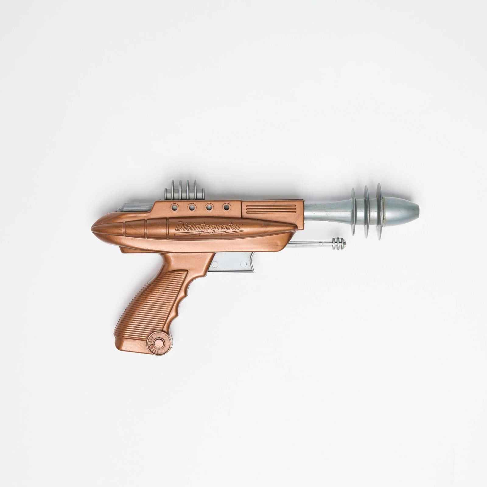 Pyro Plastics Corp. Pyrotomic Disintegrator: Pyro Plastics Corp. Pyrotomic Disintegrator molded plastic 5 h x 9.5 w x 1.75 d in (13 x 24 x 4 cm) A grail to space and ray gun collectors, with this being a bi-color example in the iconic metallic c