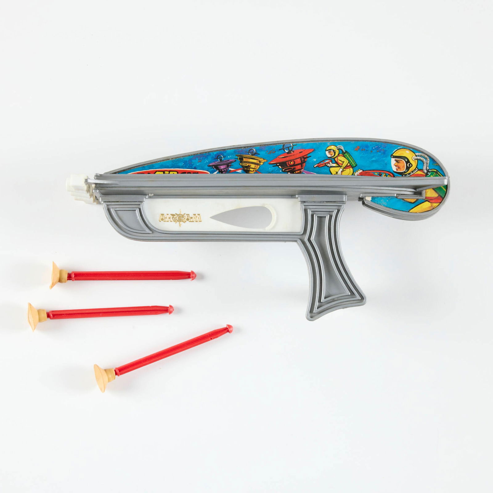 Spanish Airgam Tri-Dart Plastic Ray Gun with Original Box: Spanish Airgam Tri-Dart Plastic Ray Gun with Original Box molded plastic, rubber 5.75 h x 11.75 w x 3.5 d in (15 x 30 x 9 cm) Sold with original packaging and three darts. Manufacturer's mark to gun a