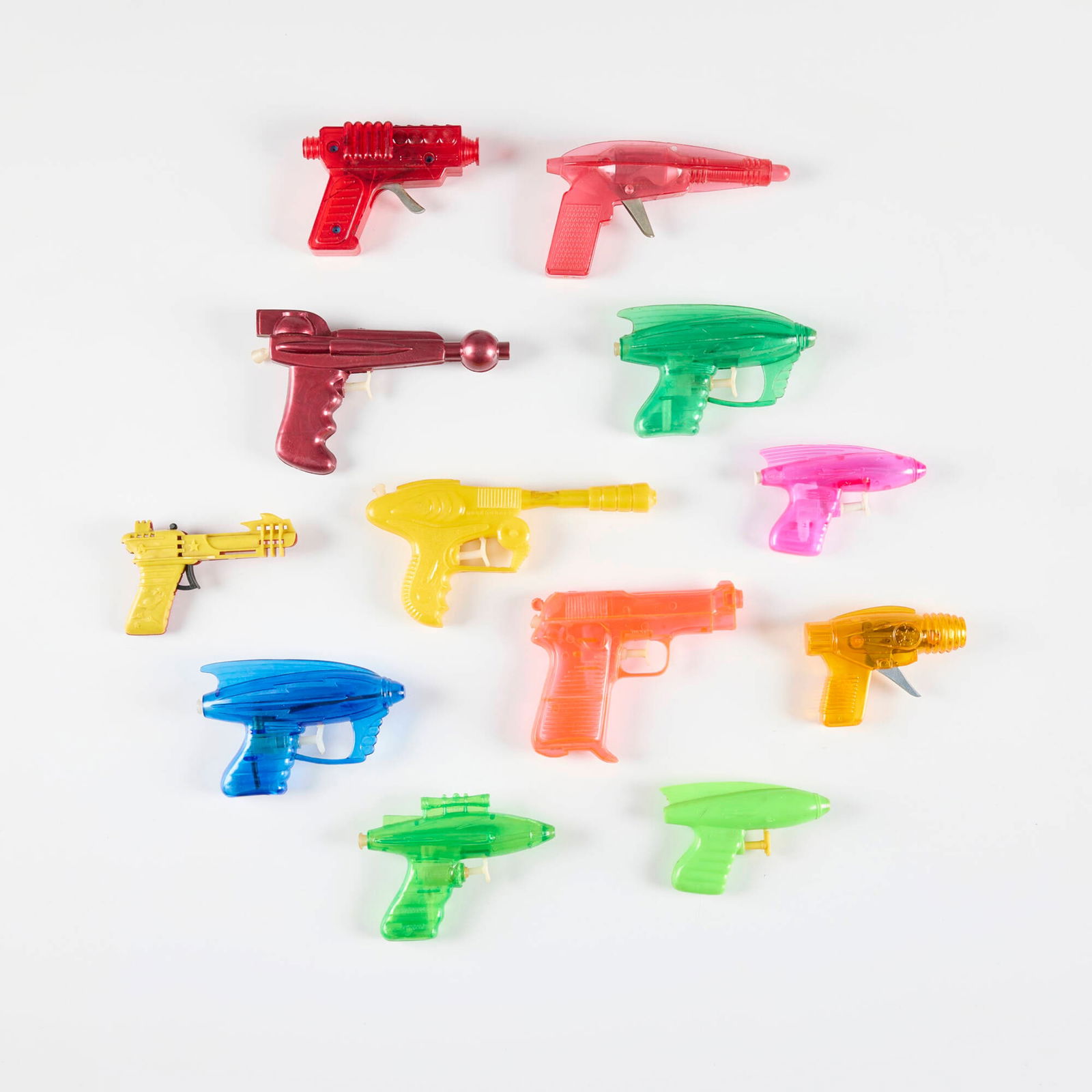 Twelve Vintage Plastic Ray Guns & Water Pistols: Twelve Vintage Plastic Ray Guns & Water Pistols molded plastic, zinc-plated steel largest: 4 h x 8 w x 1 d in (10 x 20 x 3 cm) smallest: 3.125 h x 4.25 w x 1 d in (8 x 11 x 3 cm) Manufacturer's mark t