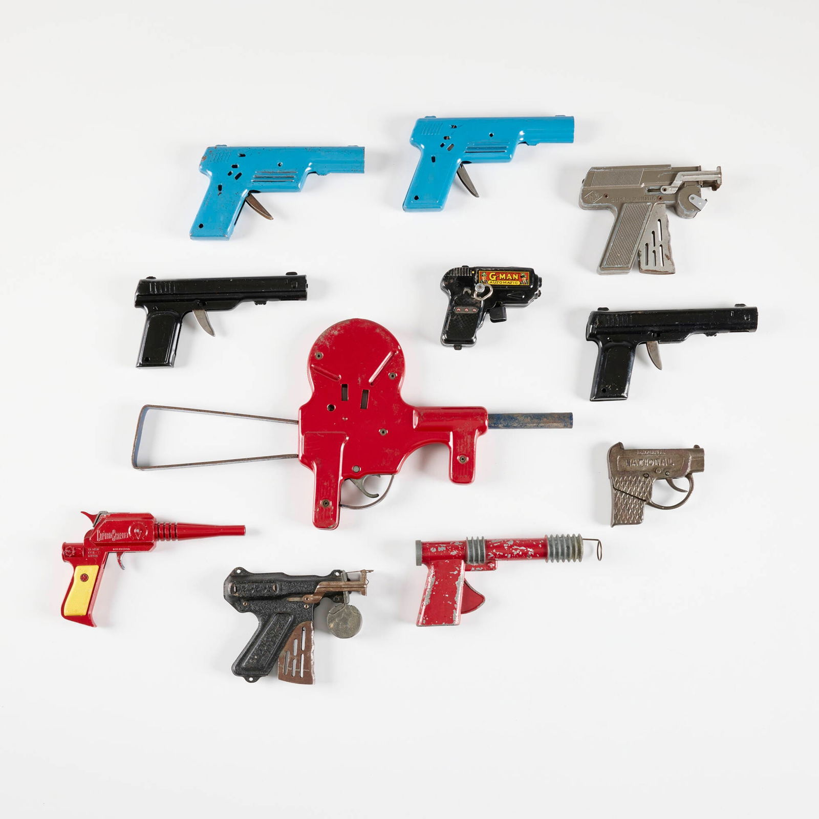 Eleven Early Metal Ray and Cap Guns: Eleven Early Metal Ray and Cap Guns enameled metal largest: 8.375 h x 17.375 w x 1 d in (21 x 44 x 3 cm) smallest: 3.25 h x 4 w x 1 d in (8 x 10 x 3 cm) Manufacturer's mark to ten examples. Condition