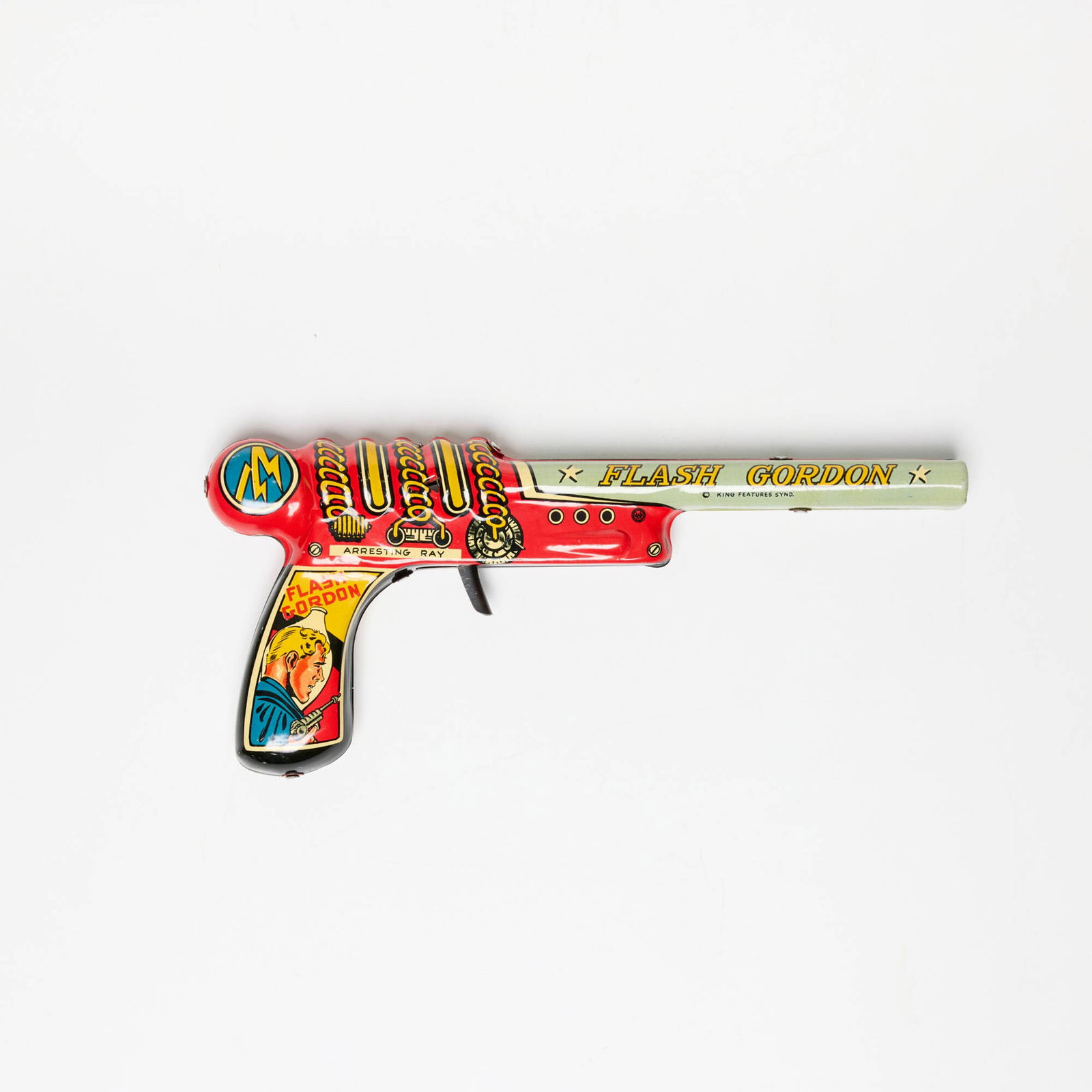 Marx Flash Gordon Tin Click Repeater: Marx Flash Gordon Tin Click Repeater transfer print on metal, patinated steel 4.5 h x 9.875 w x 1.375 d in (11 x 25 x 3 cm) Printed manufacturer's mark to side 'Flash Gordon King Features Synd.'. Cond