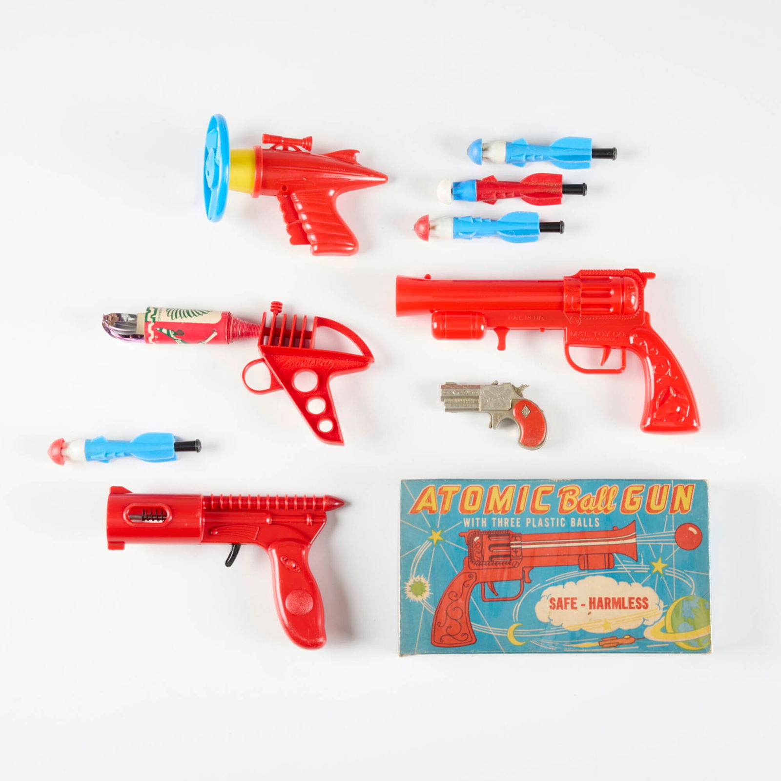 Six Vintage Ray Guns with Original Box: Six Vintage Ray Guns with Original Box plastic, printed paper, wood largest: 7.5 h x 9.25 w x 2 d in (19 x 23 x 5 cm) smallest: 3 h x 6 w x 1 d in (8 x 15 x 3 cm) Condition Notes: Each example in th