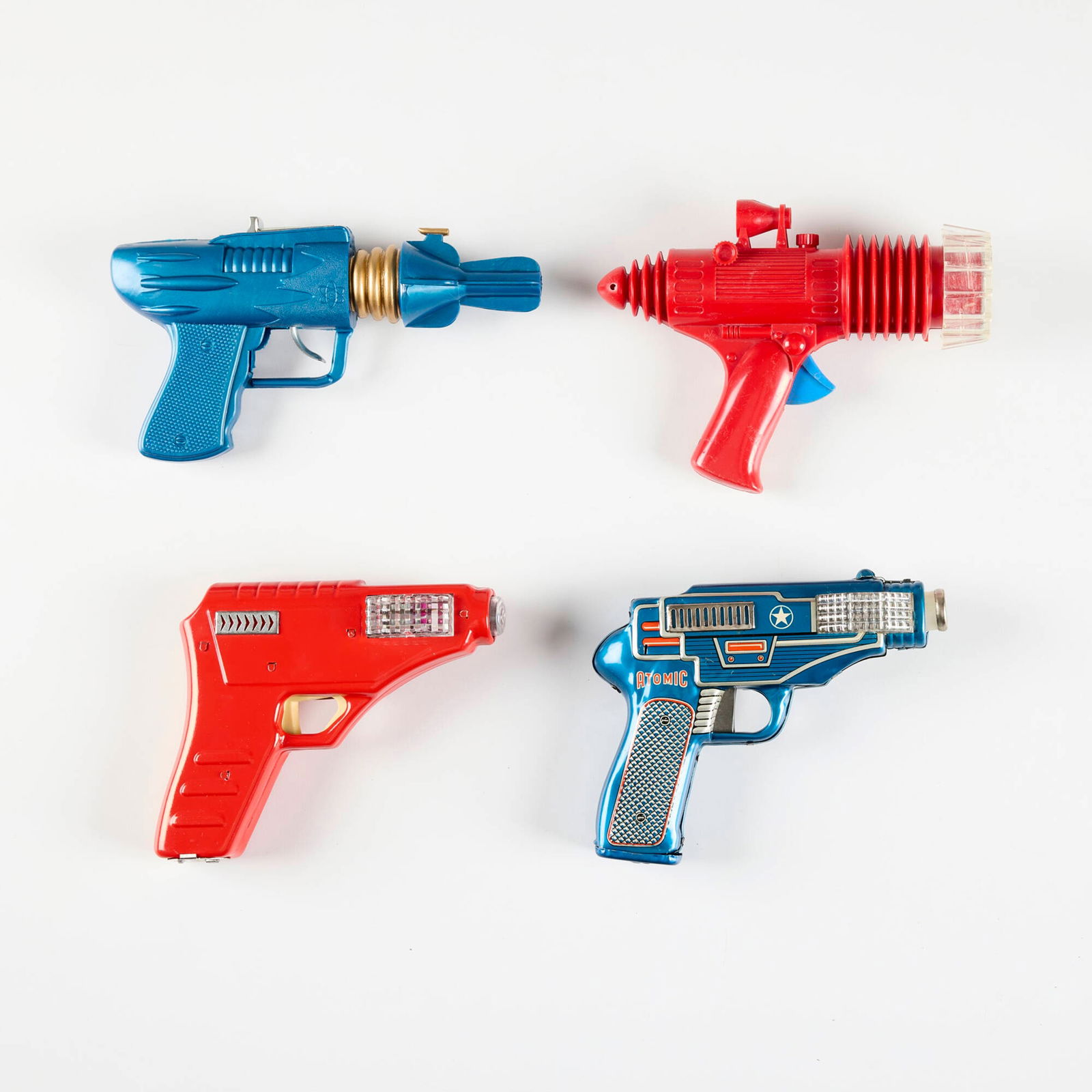 Four Vintage Ray Guns with Original Box: Four Vintage Ray Guns with Original Box painted metal, plastic, printed paper largest: 5 h x 7.5 w x 2.25 d in (13 x 19 x 6 cm) smallest: 5.5 h x 7 w x 2 d in (14 x 18 x 5 cm) Condition Notes: Each