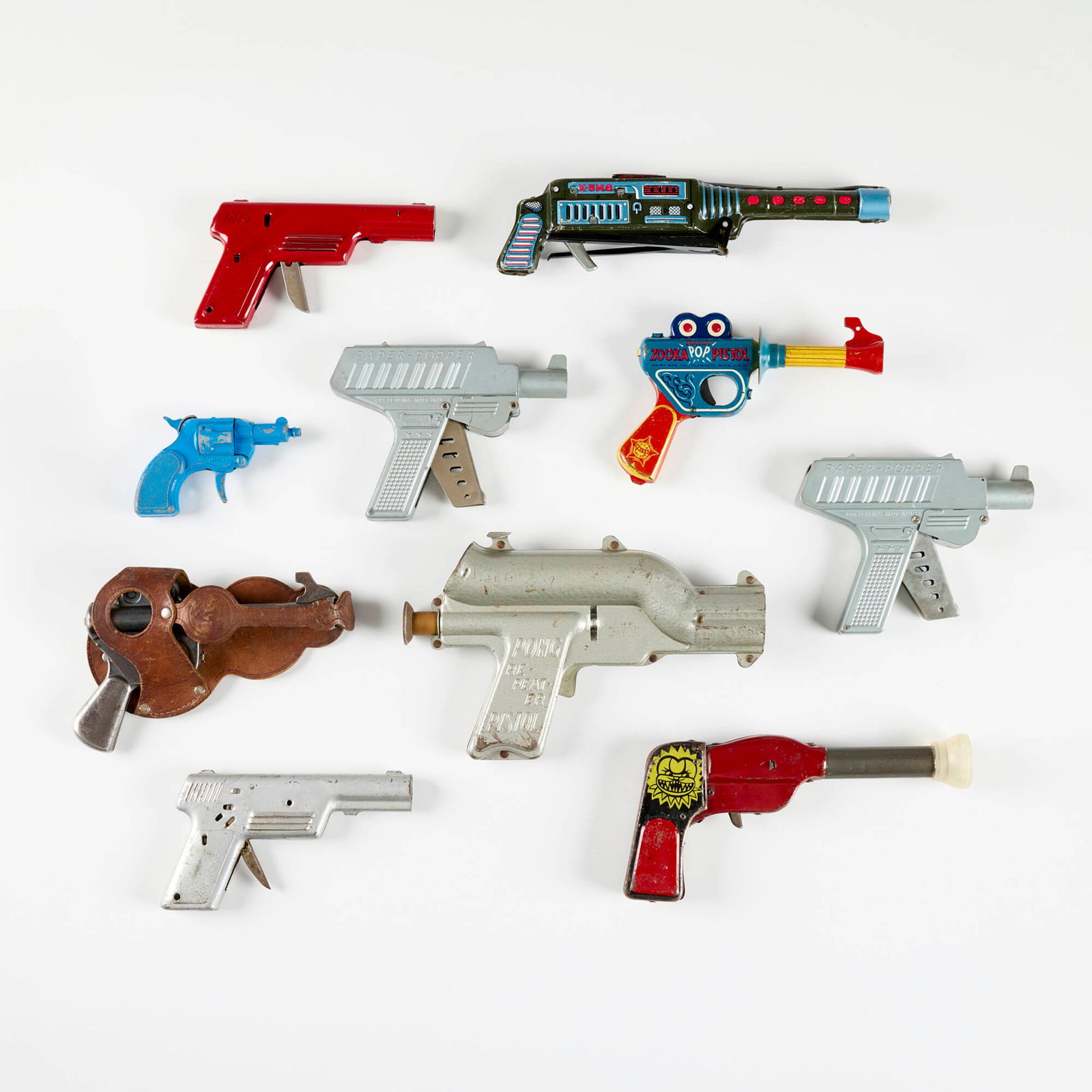 Ten Early Metal and Tin Ray Guns: Ten Early Metal and Tin Ray Guns painted metal, transfer-printed metal leather largest: 6.5 h x 10 w x 1.75 d in (17 x 25 x 4 cm) smallest: 3 h x 4.75 w x 1.25 d in (8 x 12 x 3 cm) Condition Notes: