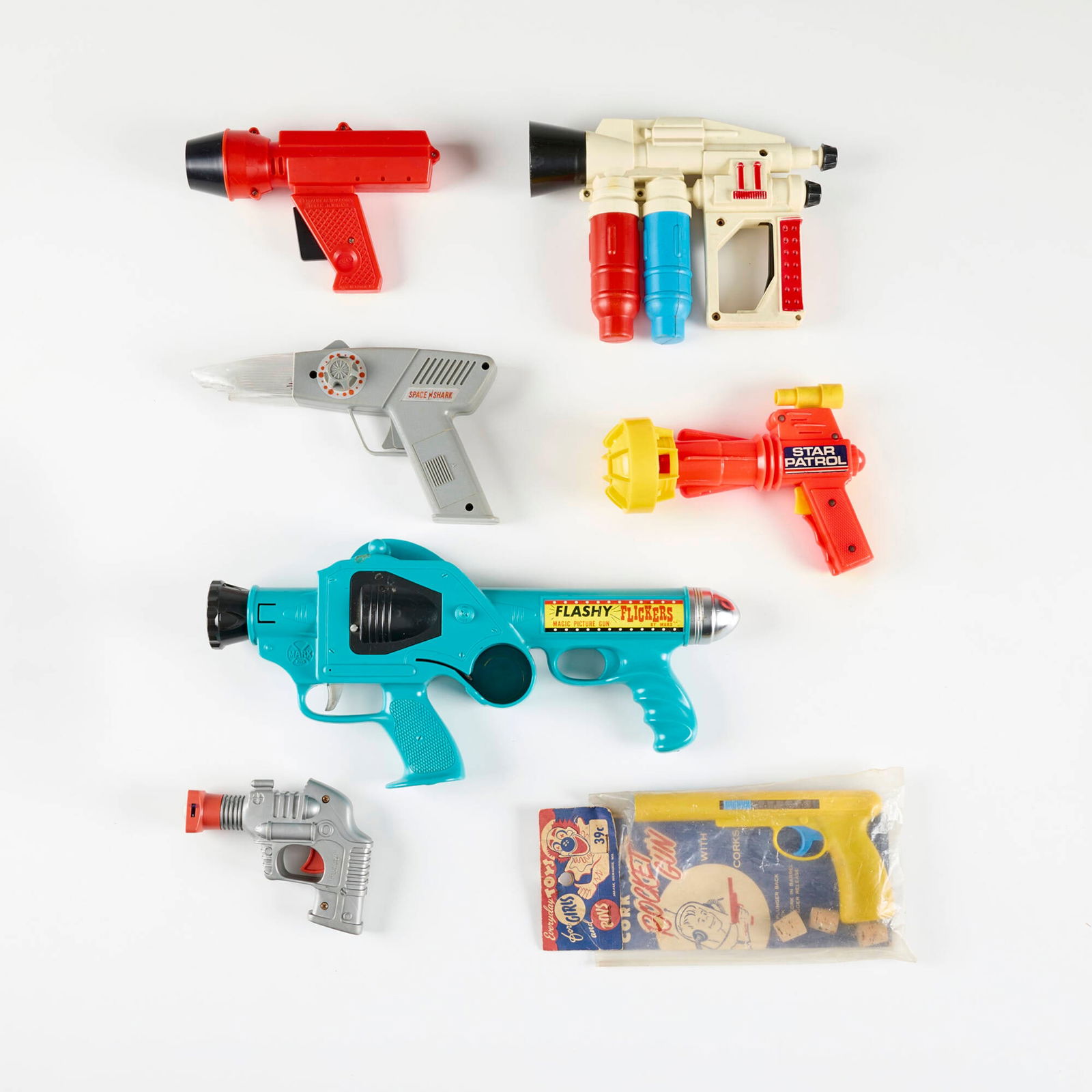 Seven Vintage Plastic Ray Guns: Seven Vintage Plastic Ray Guns plastic largest: 7 h x 14.75 w x 2 d in (18 x 37 x 5 cm) smallest: 4 h x 5.25 w x 1.5 d in (10 x 13 x 4 cm) Condition Notes: Each example in this lot comes from a sing
