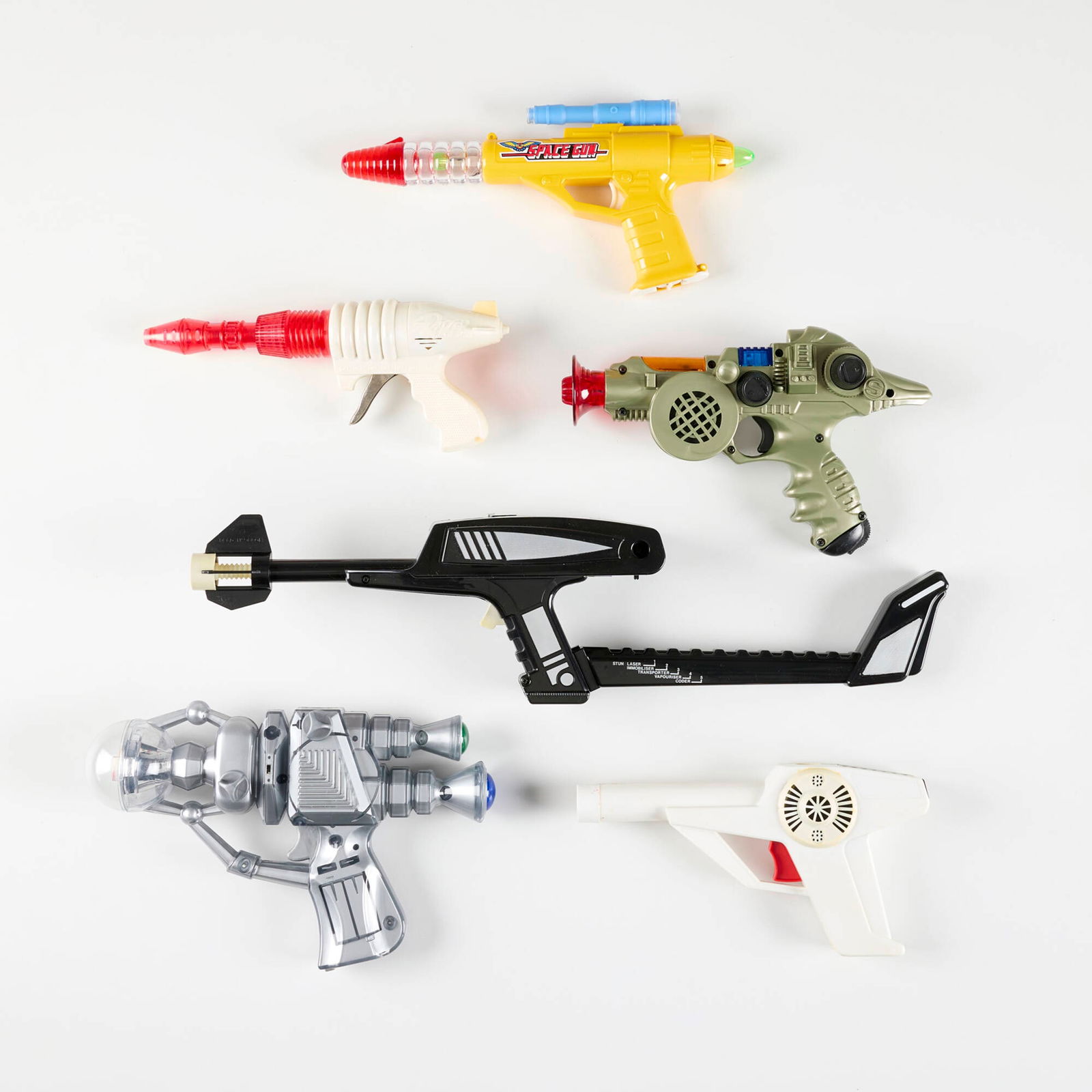 Six Vintage Plastic Ray Guns with Original Box: Six Vintage Plastic Ray Guns with Original Box molded plastic, zinc-plated steel 5 h x 20 w x 3.875 d in (13 x 51 x 10 cm) 5.125 h x 9.25 w x 1.625 d in (13 x 23 x 4 cm) Sold with original packaging f
