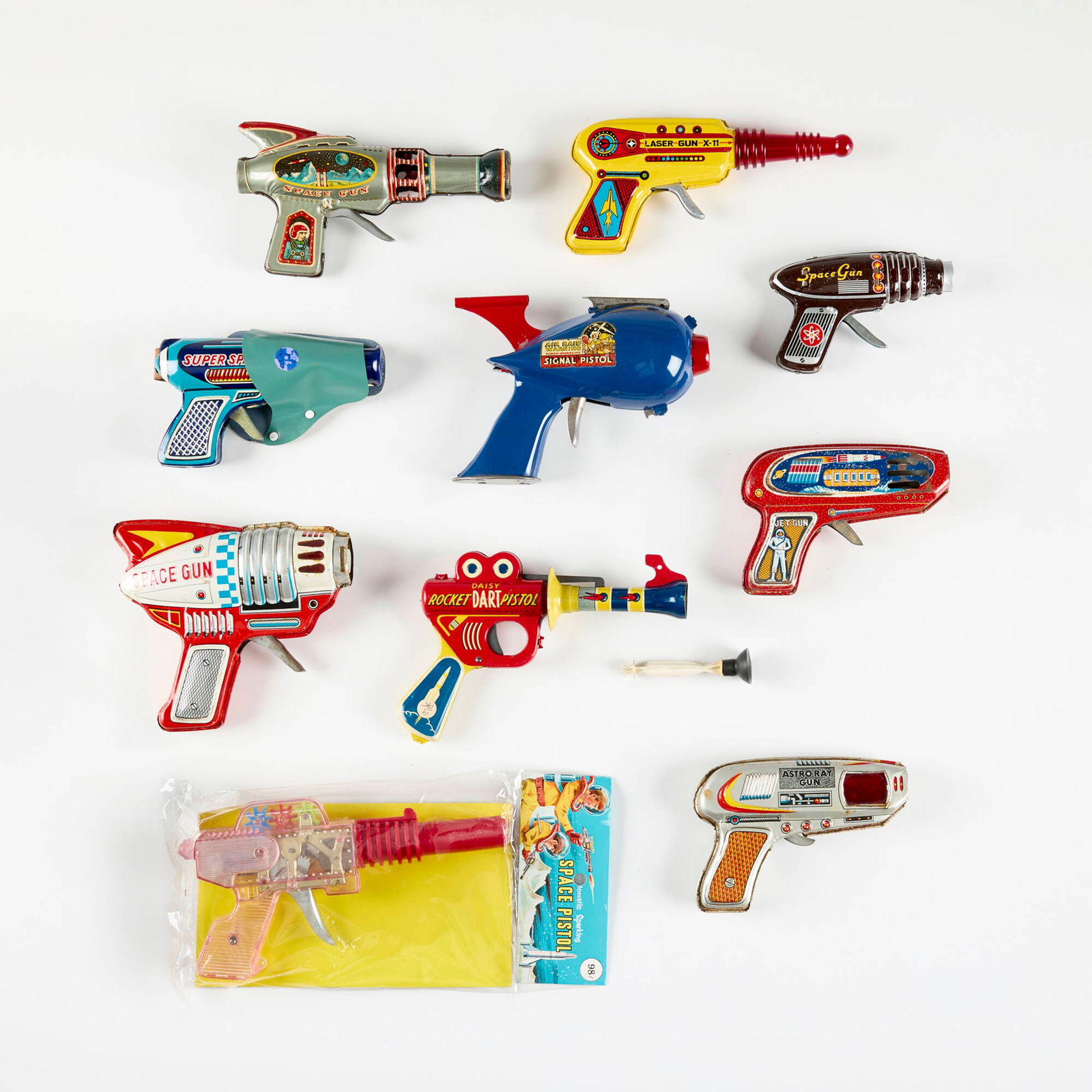 Ten Vintage Plastic and Tin Ray Guns: Ten Vintage Plastic and Tin Ray Guns transfer print on metal, molded plastic, zinc-plated steel largest: 4.75 h x 7 w x 2.5 d in (12 x 18 x 6 cm) smallest: 3.375 h x 5 w x 1.125 d in (9 x 13 x 3 cm) M