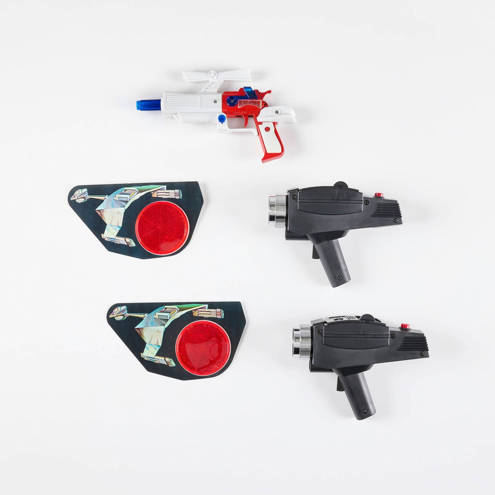 Two Stark Trek Super Phaser II Target Game and Flash Gordon Pistol: Two Stark Trek Super Phaser II Target Game and Flash Gordon Pistol molded plastic, zinc-plated steel, enameled metal 6 h x 9.5 w x 1.25 d in (15 x 24 x 3 cm) 6 h x 7.75 w x 2.375 d in (15 x 20 x 6 cm)