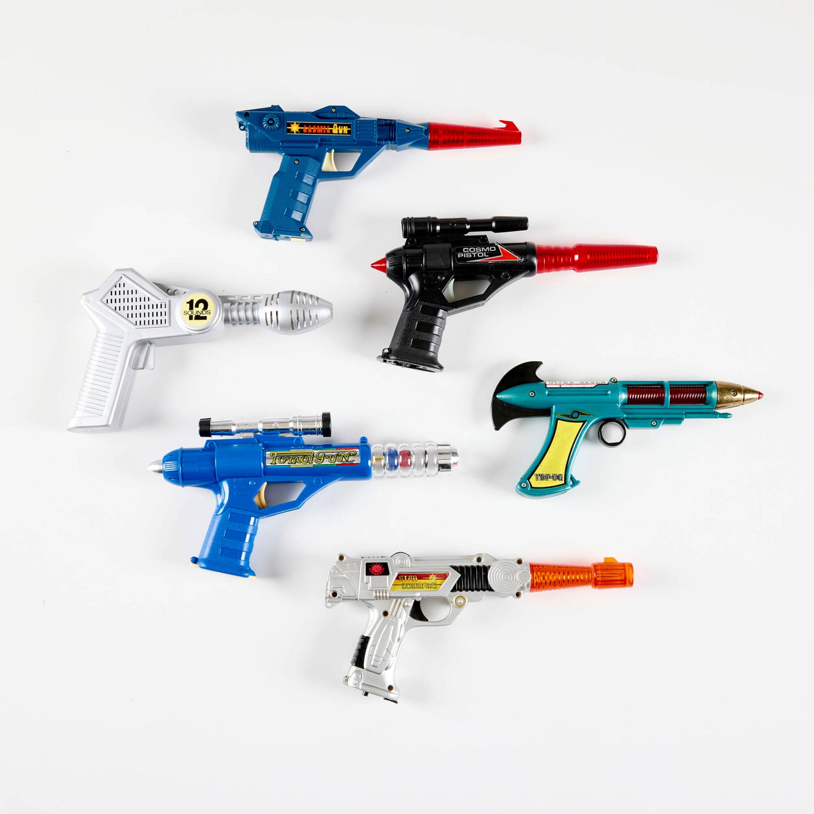 Six Vintage Plastic Ray Guns with Original Box: Six Vintage Plastic Ray Guns with Original Box molded plastic largest: 5.75 h x 10.75 w x 1.5 d in (15 x 27 x 4 cm) smallest: 4.75 h x 9.5 w x 1 d in (12 x 24 x 3 cm) Manufacturer's mark to packaging