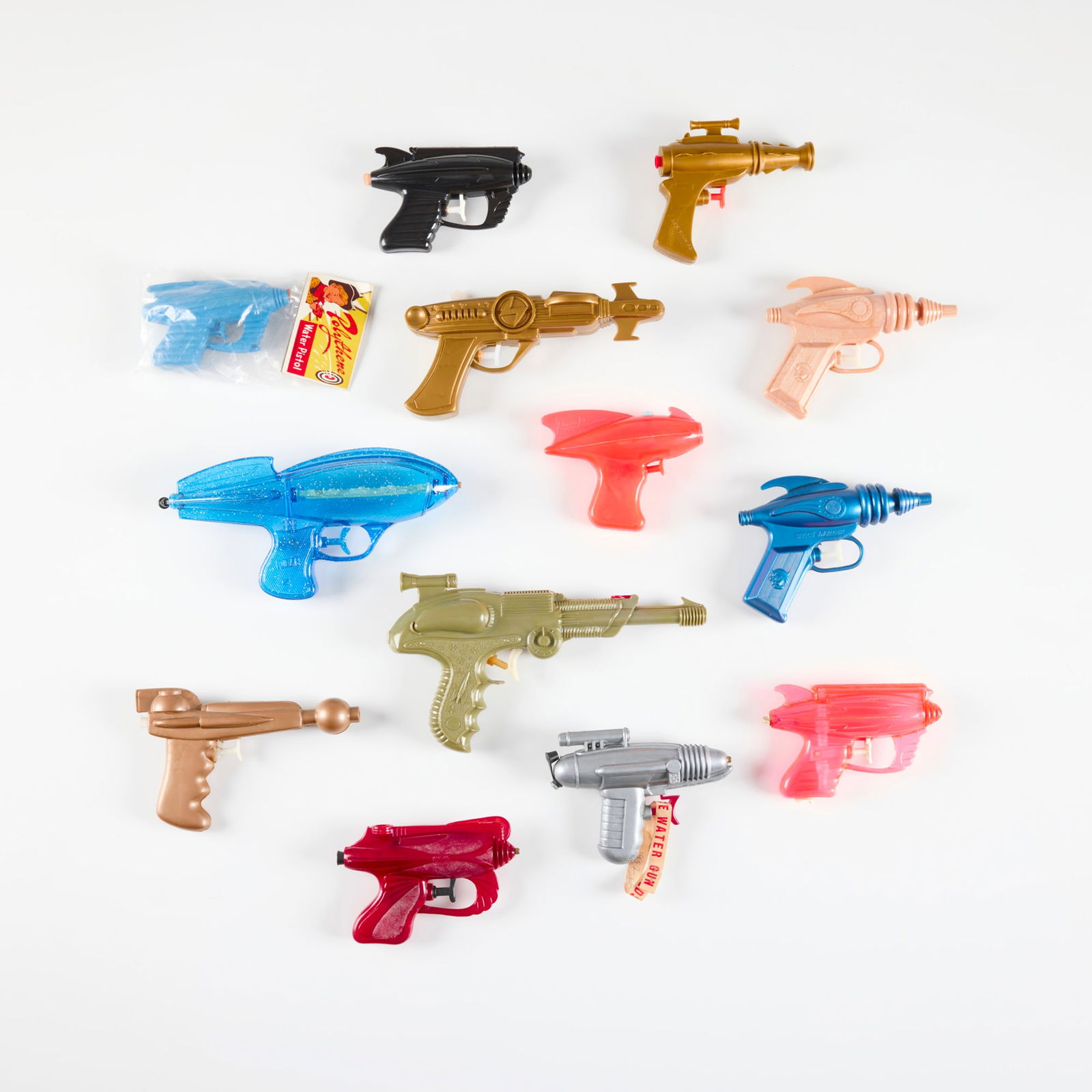 Thirteen Vintage Plastic Ray Guns and Water Pistols: Thirteen Vintage Plastic Ray Guns and Water Pistols molded plastic largest: 5.5 h x 10 w x 1.75 d in (14 x 25 x 4 cm) smallest: 4 h x 5 w x 1.25 d in (10 x 13 x 3 cm) Manufacturer's mark to eleven exa
