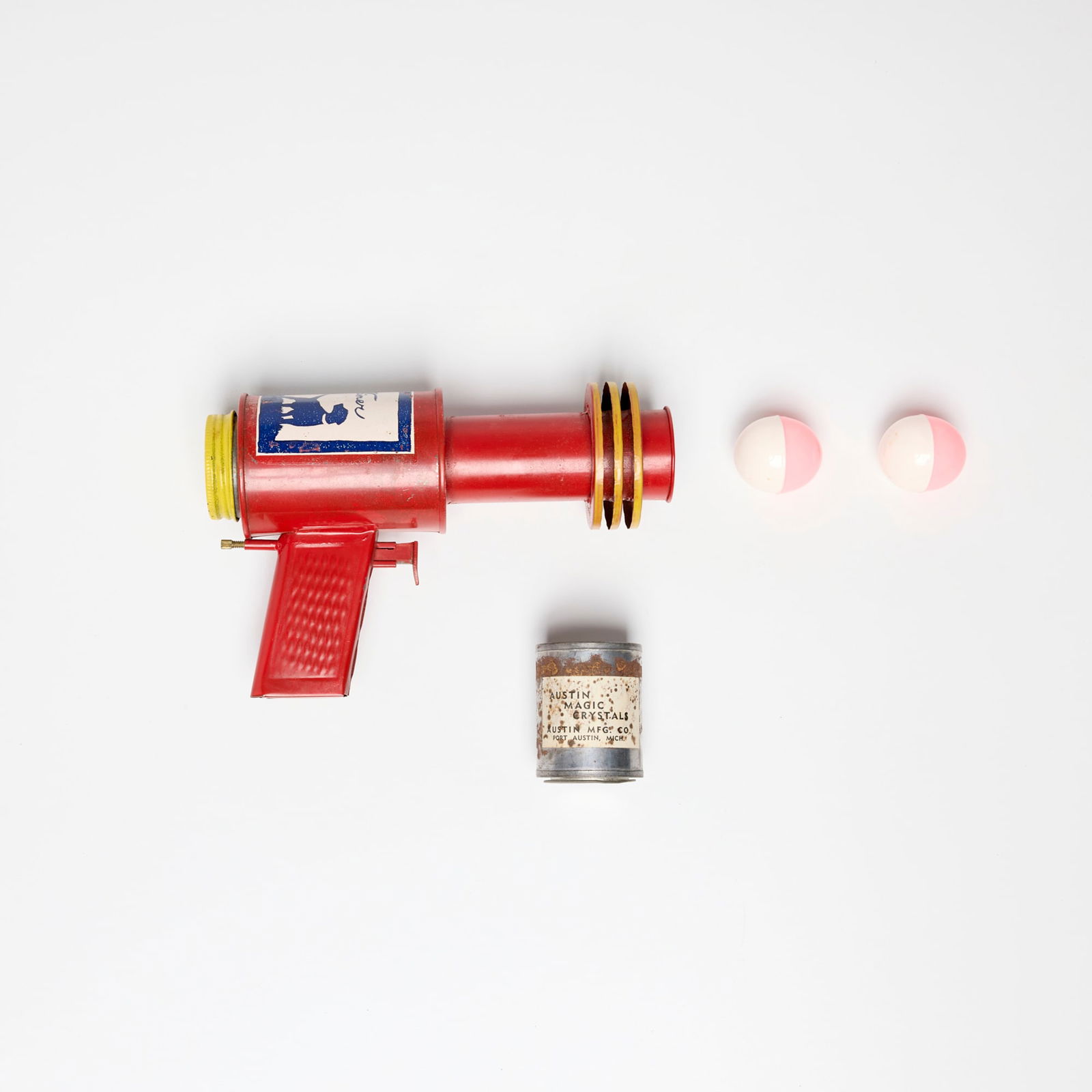 Austin Manufacturing Austin Magic Pistol with Original Box: Austin Manufacturing Austin Magic Pistol with Original Box screenprint on lacquered metal, molded plastic, zinc-plated steel 5.25 h x 7.875 w x 2.375 d in (13 x 20 x 6 cm) Sold with original packaging