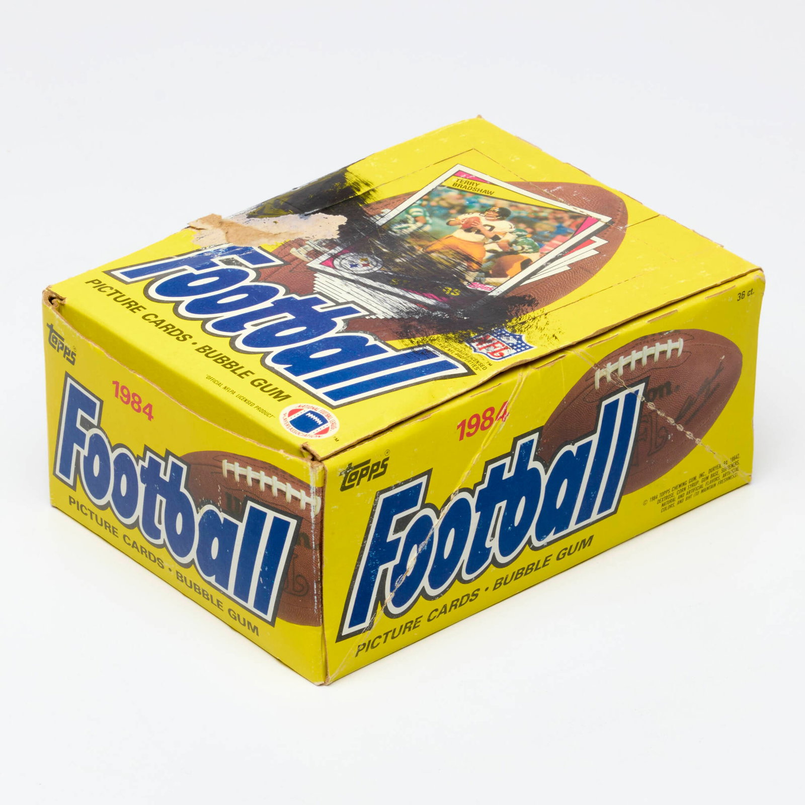 1984 Topps Football 36 Count Complete Wax Box: 1984 Topps Football 36 Count Complete Wax Box USA, 1984 Complete box with 36 sealed packs. Each pack with 15 cards and 1 piece of gum. Possible Rookies include #63 John Elway and #123 Dan Marino. Blac