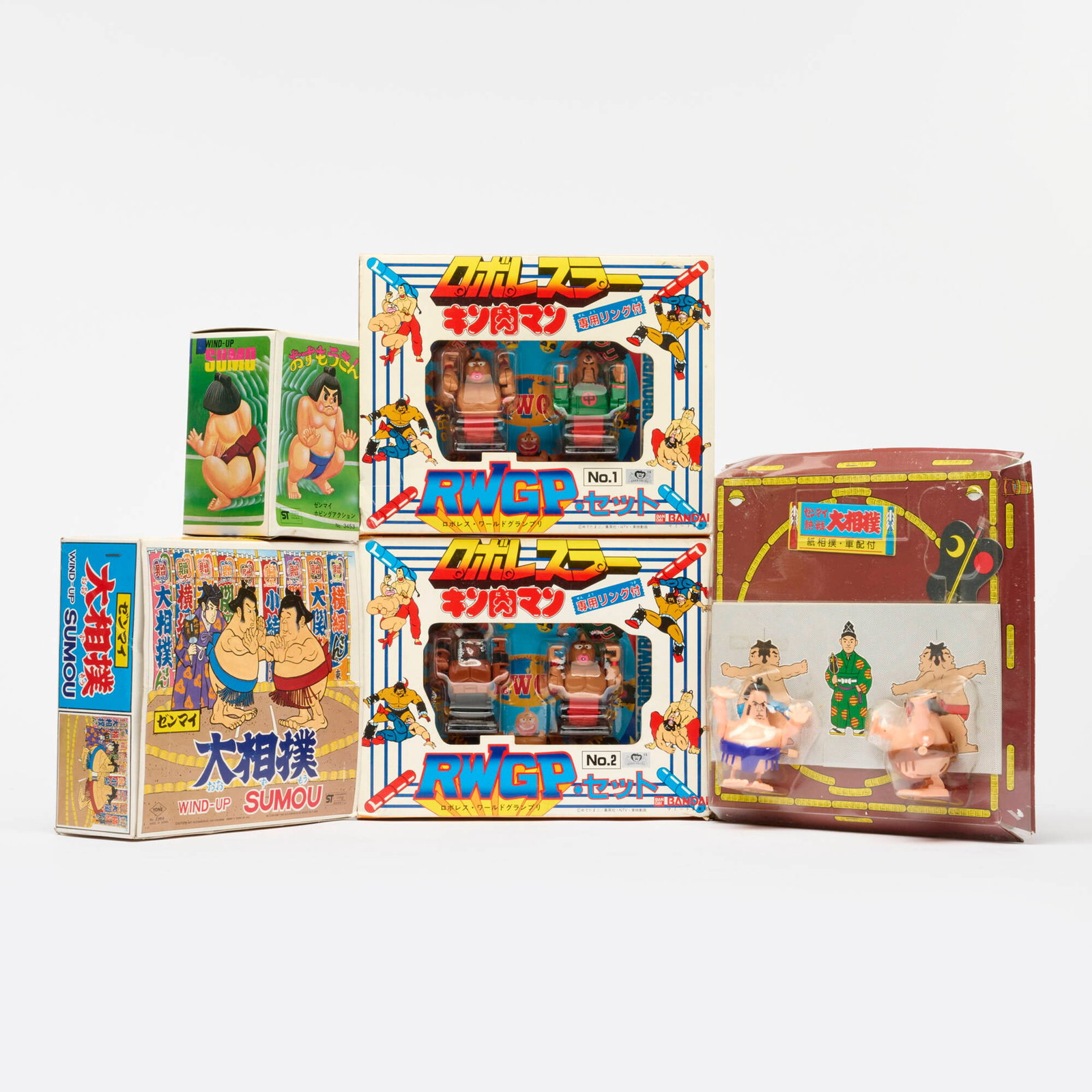 5PC Kinnikuman Robo Wrestler Grand Prix and Sumo Wrestler Wind-Up Toy Group: 5PC Kinnikuman Robo Wrestler Grand Prix and Sumo Wrestler Wind-Up Toy Group Japan smallest: 5 h x 3.5 w x 3 d in (13 x 9 x 8 cm) largest: 9.5 h x 9.5 w x 2.5 d in (24 x 24 x 6 cm) Group includes: Band