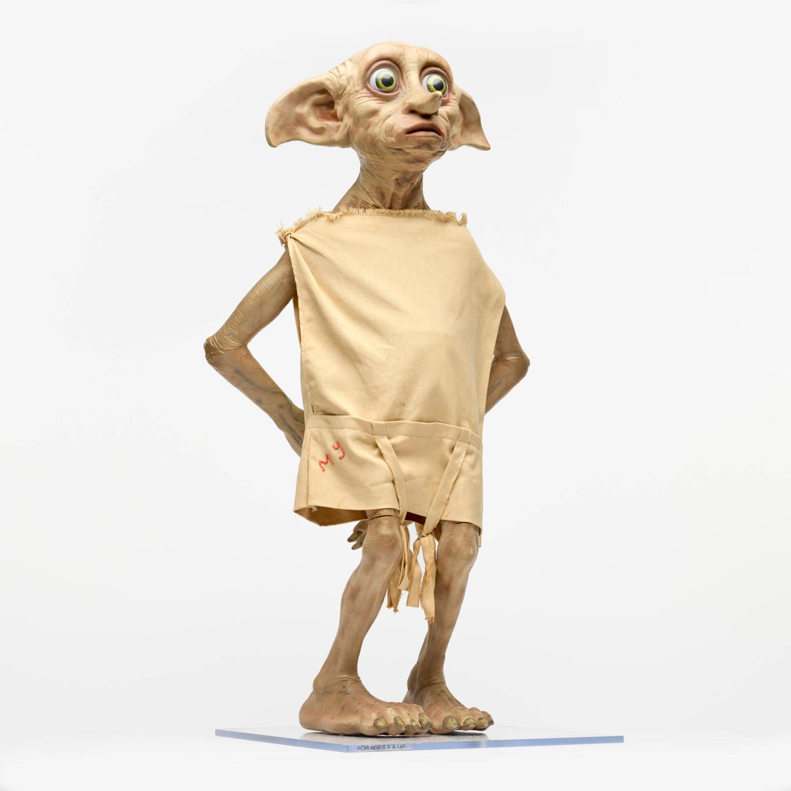 Harry Potter and the Chamber of Secrets Dobby Life Size Statue: Harry Potter and the Chamber of Secrets Dobby Life Size Statue USA vinyl, cloth, plastic 28 h x 11.75 w x 11.75 d in (71 x 30 x 30 cm) Measures 28 inches tall. Attached to clear plastic base.Condition