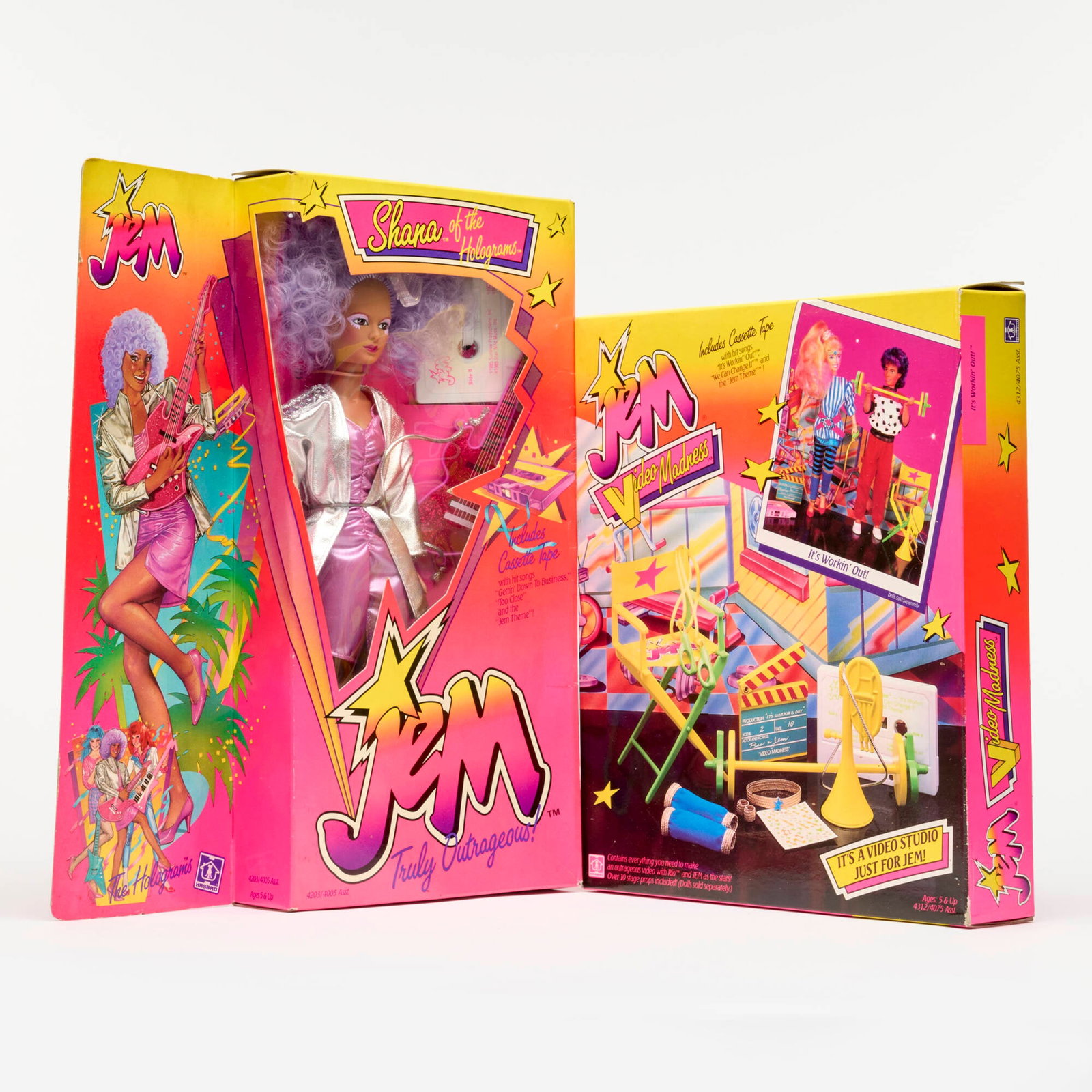 Hasbro JEM and the Holograms Shana of the Holograms Video Madness It's Working Out: 2PC 1985-1986 Hasbro JEM and the Holograms Shana of the Holograms and Video Madness It's Working Out Group Factory Sealed USA, 1985-1986 14.5 h x 12 w x 2 d in (37 x 30 x 5 cm) 12 h x 10.5 w x 2 d in 