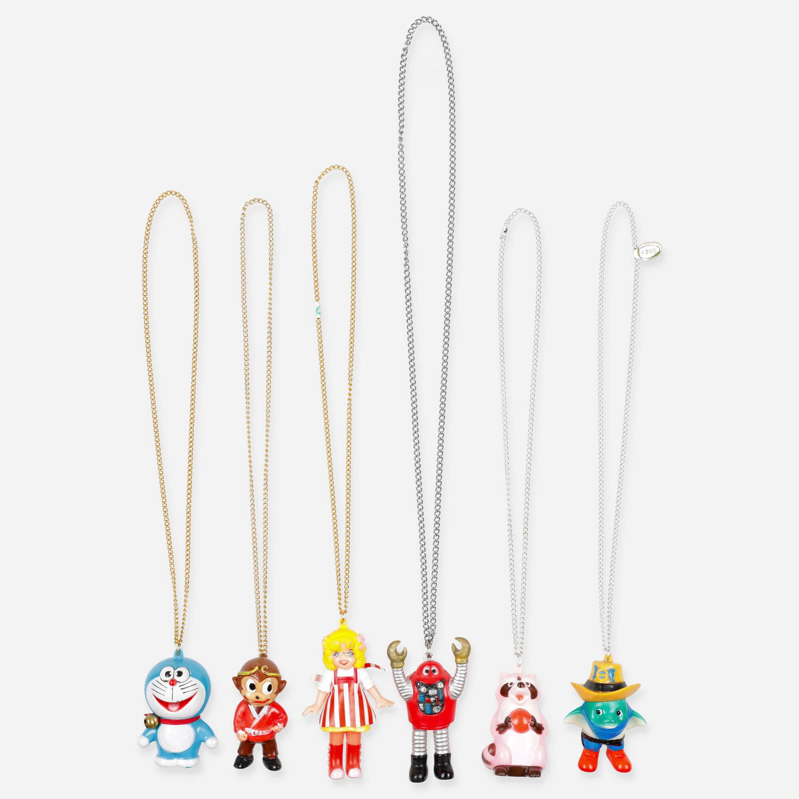 Tokusatsu and Related Character Mini Vinyl Necklace Group: Tokusatsu and Related Character Mini Vinyl Necklace Group Unknown Japan, c. 1970 3 h x 1.75 w x 1.75 d x 14.5 l in (8 x 4 x 4 x 37 cm) 3.75 h x 2.25 w x 1.25 d x 19.75 l in (10 x 6 x 3 x 50 cm) Group 