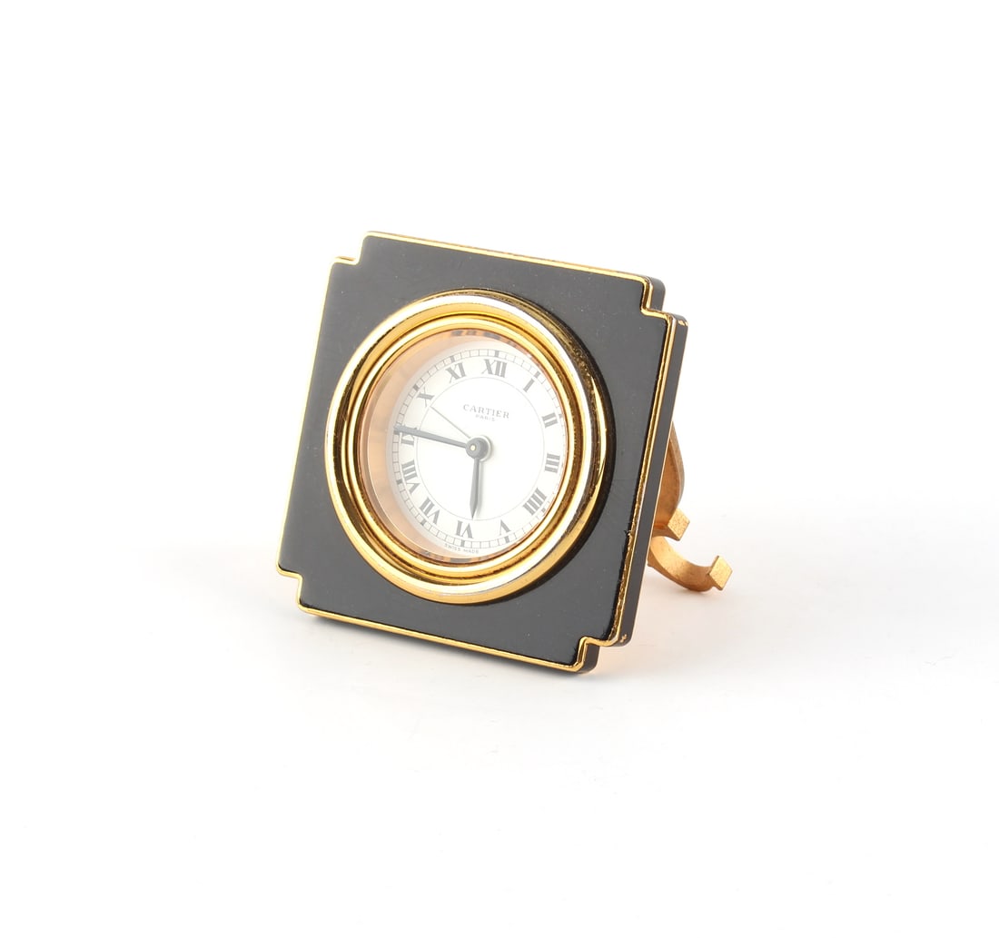 Cartier - a gilt & black enamel folding travel clock, mechanical, appears to be working (1 of 2)