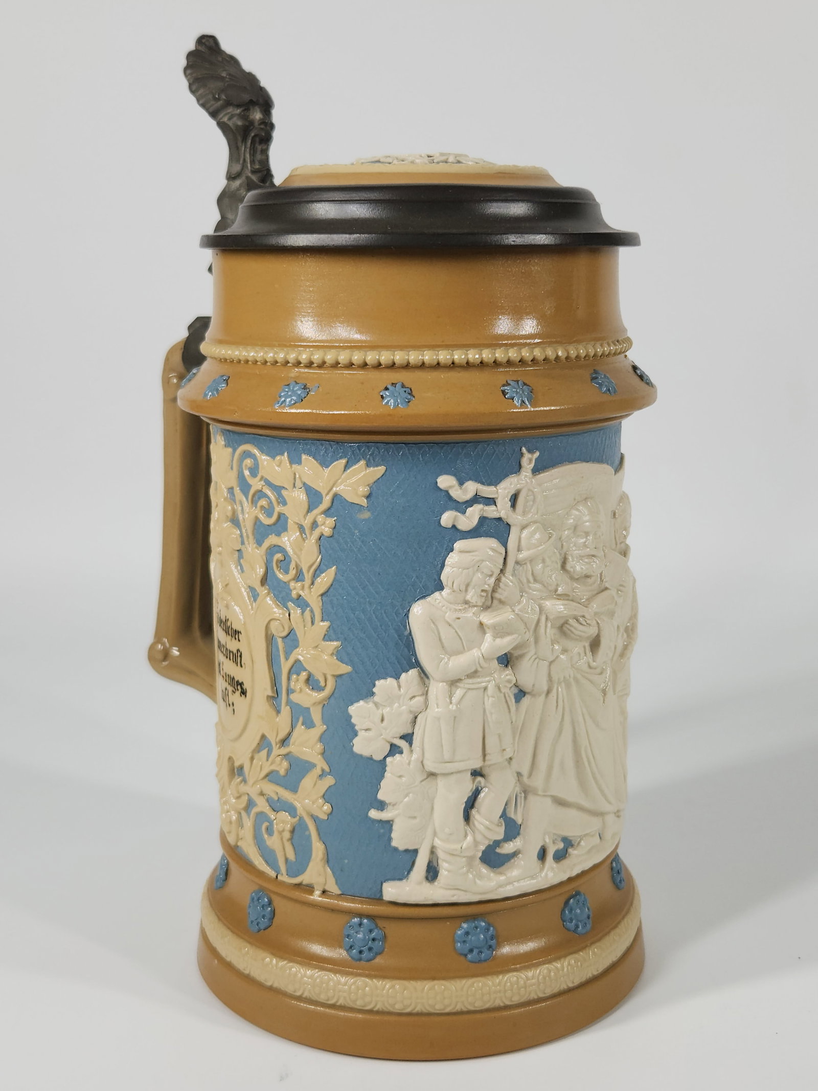 ANTIQUE METTLACH JASPERWARE STEIN: REMAINS IN VERY GOOD CLEAN CONDITION. MEASURES APPROXIMATELY 9 3/4" TALL.