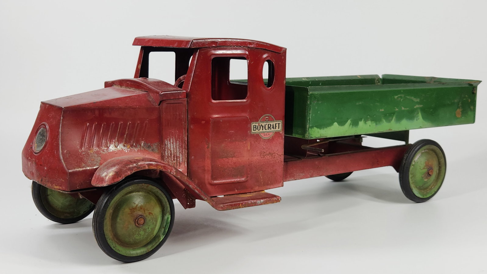 BOYCRAFT STEELCRAFT PRESSED STEEL MACK DUMP TRUCK: REMAINS IN FAIR TO GOOD CONDITION, SHOWING USAGE WEAR. APPEARS TO HAVE BEEN SITTING IN WATER. MEASURES APPROXIMATELY 23" LONG.
