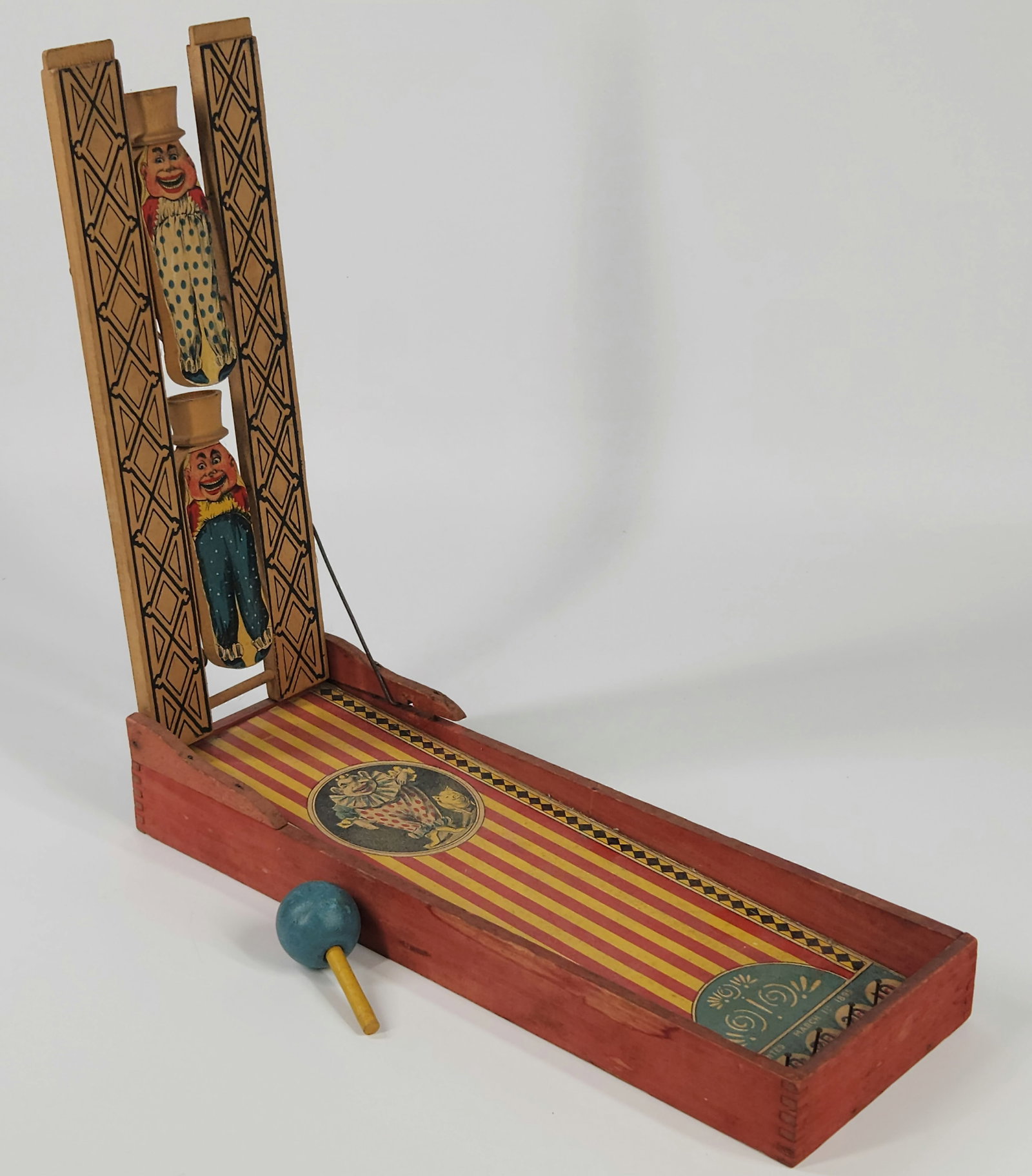 1800'S PAPER LITHO & WOOD CLOWN GAME: REMAINS IN GOOD CONDITION, SHOWING SOME TYPICAL WEAR. PAPER LITHO REMAINS NICE. MEASURES APPROXIMATELY 13" LONG BY 13" TALL.