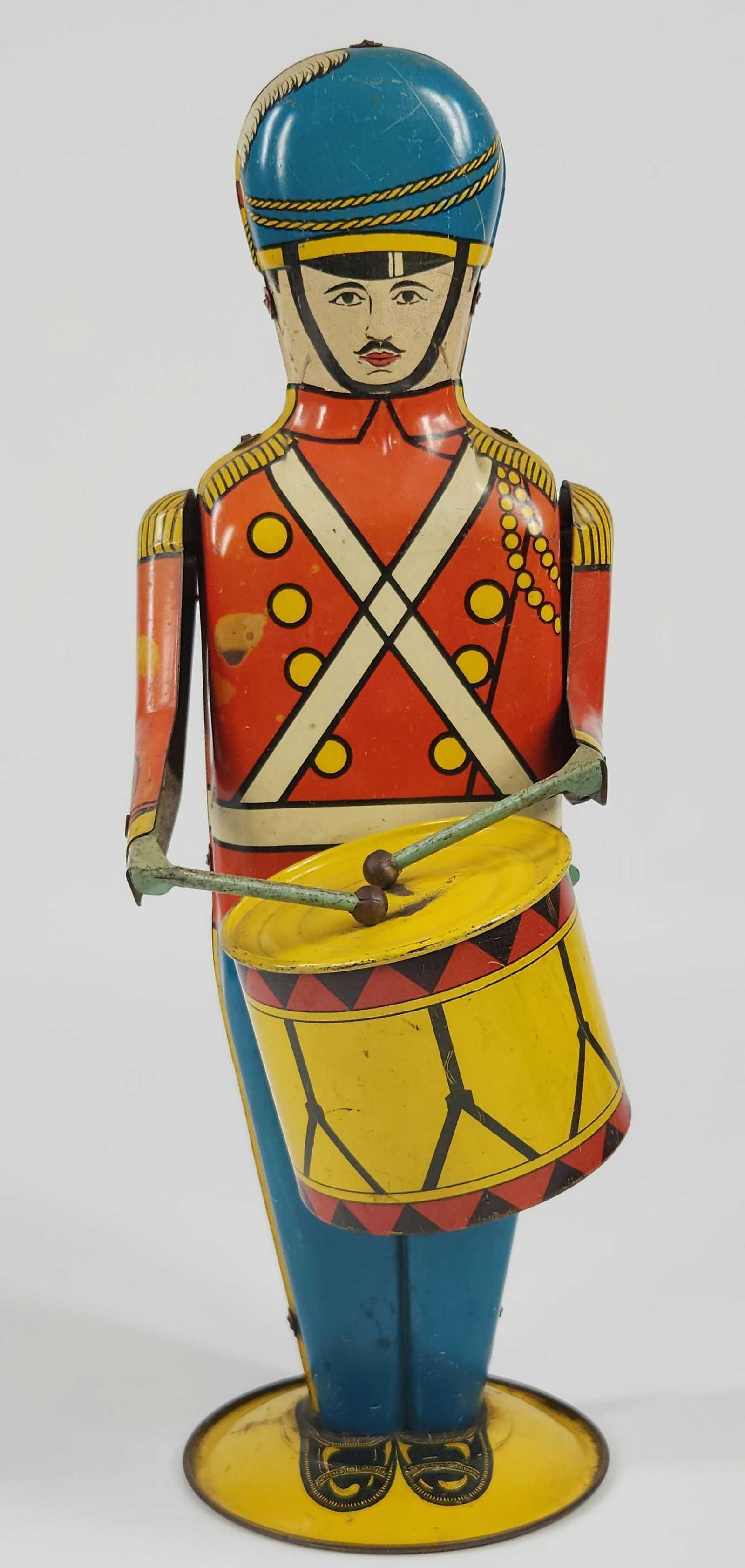 WOLVERINE NO. 27 TIN WIND UP DRUM MAJOR: REMAINS IN GOOD CONDITION, SHOWING SOME TYPICAL WEAR. WIND UP MECHANISM WORKS. MEASURES APPROXIMATELY 15.5" TALL.