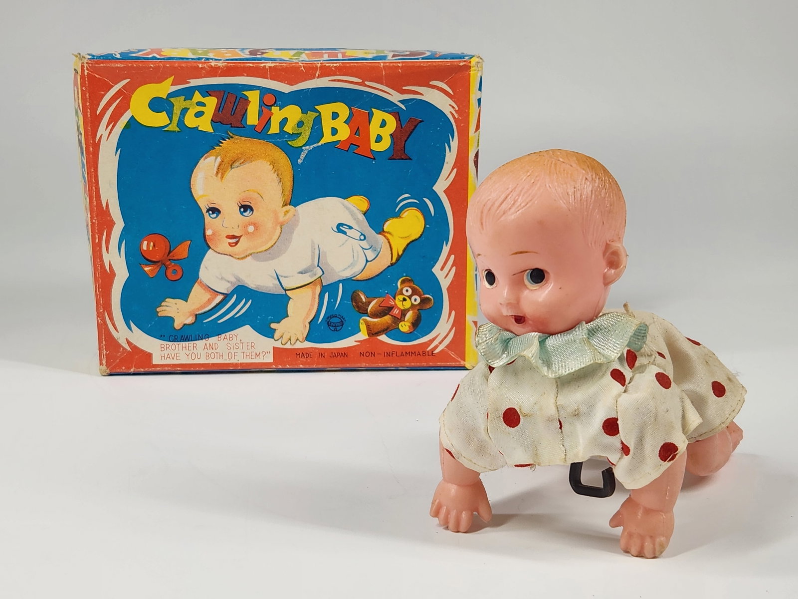 JAPAN PLASTIC WIND UP CRAWLING BABY W/ BOX: REMAINS IN GOOD WORKING CONDITION. BOX REMAINS NICE, SHOWING SOME WEAR. MEASURES APPROXIMATELY 4.5" LONG.