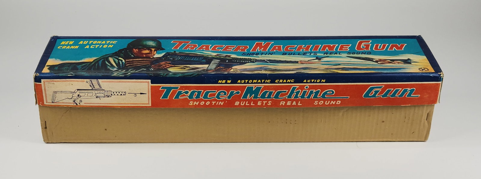 EMPTY K JAPAN TACER MACHINE GUN BOX: EMPTY BOX ONLY REMAINS IN GOOD CONDITION, SHOWING SOME TYPICAL WEAR. INCLUDES PLASTIC BULLETS NEW IN PACKAGE. AND PART OF THE SIDE OF THE TOY GUN. MEASURES APPROXIMATELY 21" LONG.