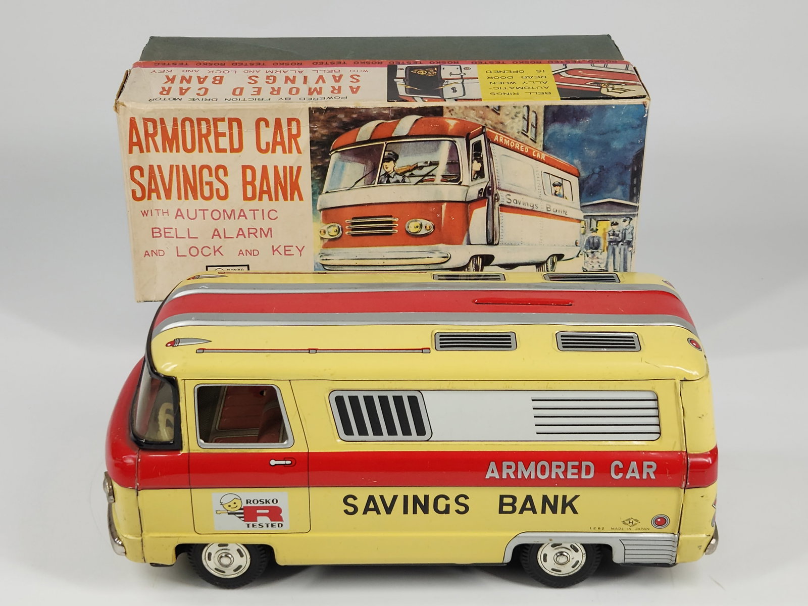 ROSKO TIN FRICTION ARMORED CAR SAVINGS BANK W/ BOX: REMAINS IN EXCELLENT VERY CLEAN CONDITION WITH ORIGINAL BOX. ORIGINAL KEY INCLUDED. FRICTION MOTOR WORKS WELL. MEASURES APPROXIMATELY 10" LONG. BOX REMAINS NICE.