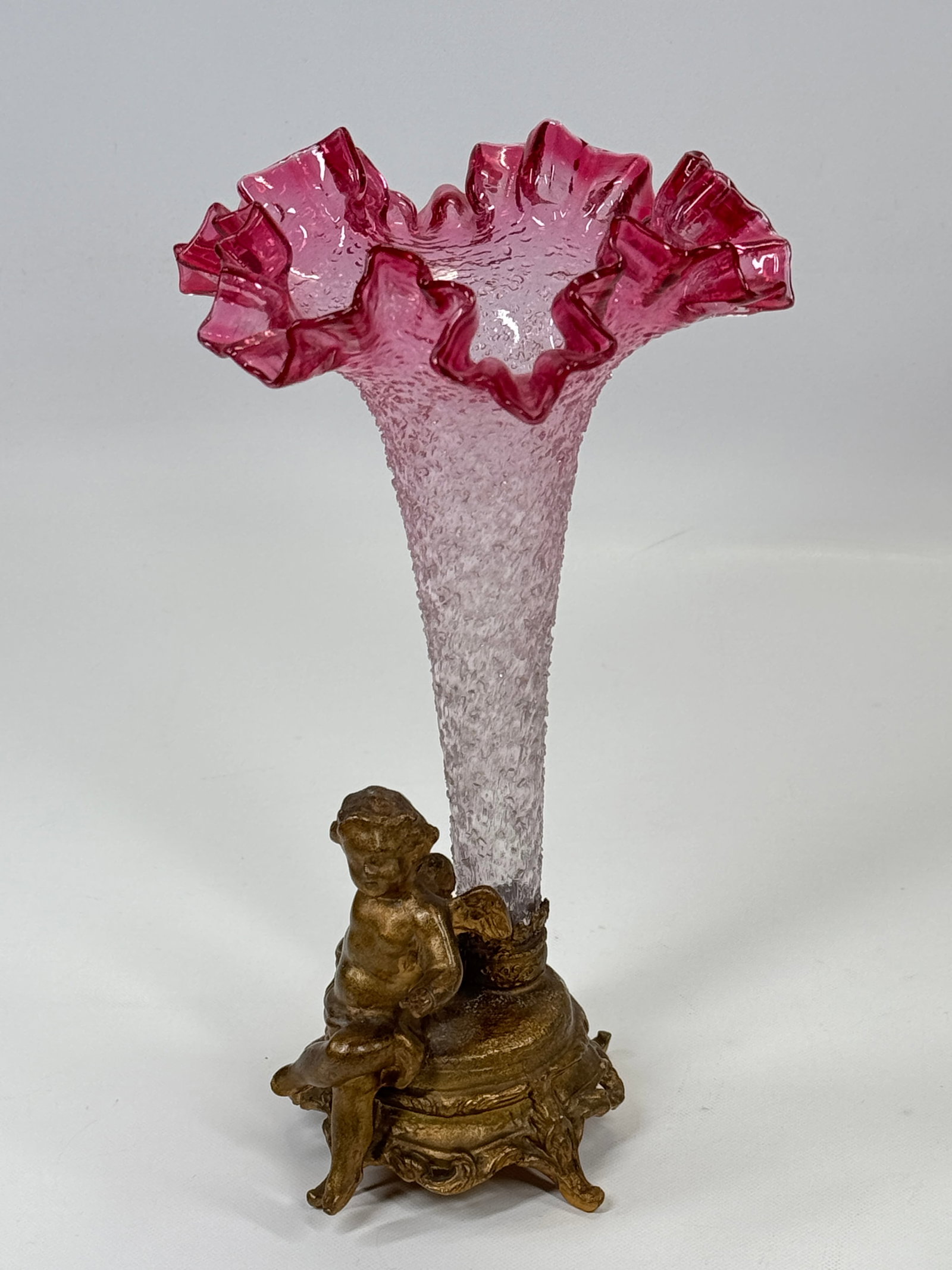 VICTORIAN CRANBERRY ART GLASS VASE W/ CHERUB HOLDER: REMAINS IN VERY GOOD CONDITION, NO CHIPS OR CRACKS. HOLDER SHOWING SOME WEAR.