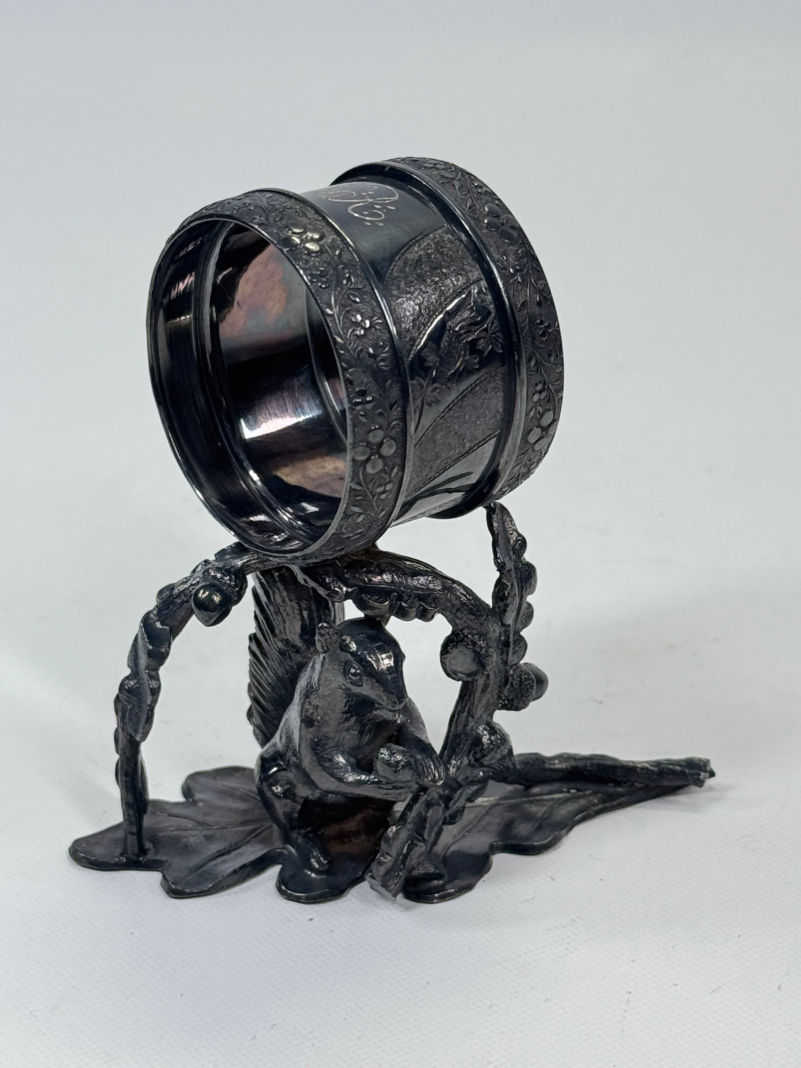 REED & BARTON SQUIRREL EATING ACORN NAPKIN HOLDER: REMAINS IN VERY GOOD CONDITION, NEEDS POLISHED.