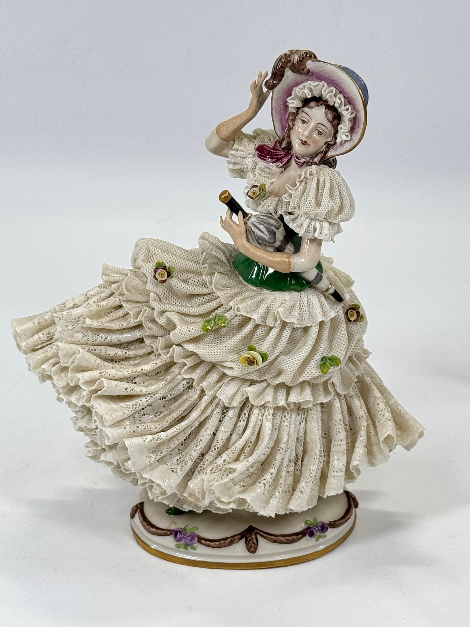 ANTIQUE GERMAN SPAGHETTI FIGURINE W/ UMBRELLA: REMAINS IN VERY GOOD CONDITION, SHOWING SOME TYPICAL WEAR. NO CHIPS OR CRACKS.