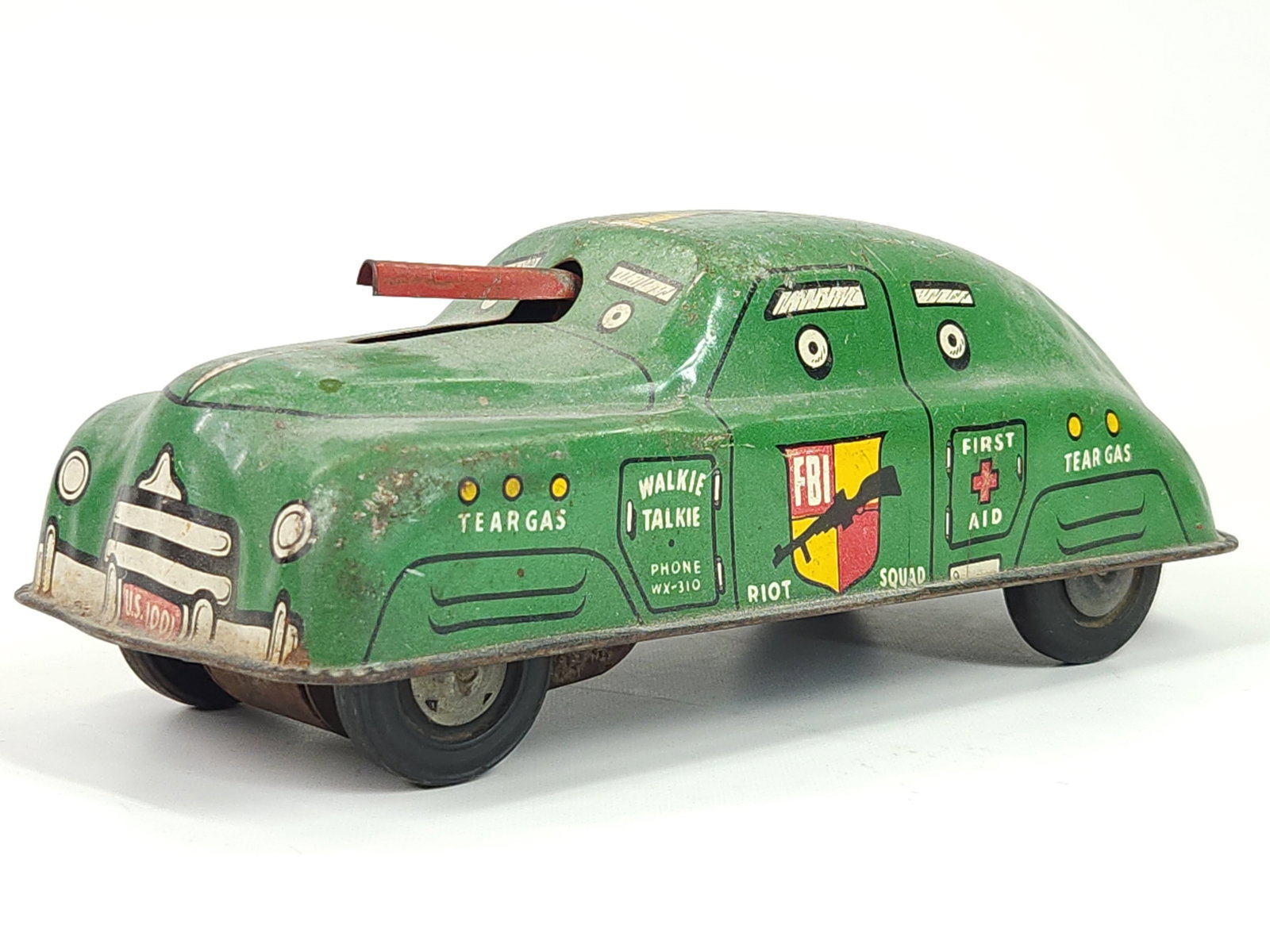 COURTLAND TIN FRICTION RIOT SQUAD CAR: REMAINS IN GOOD USED CONDITION, SHOWING TYPICAL WEAR. FRICTION MOTOR WORKS.