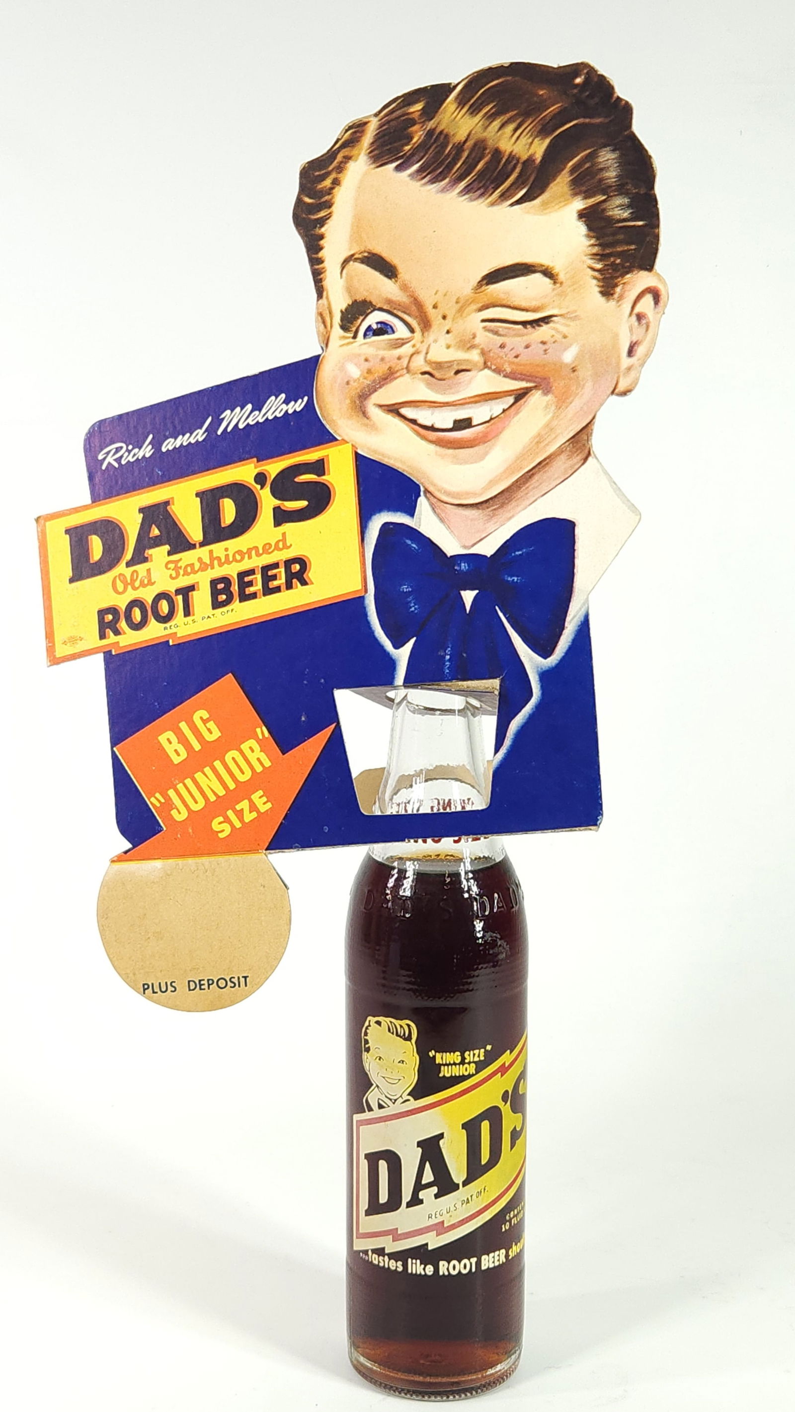 DAD'S ROOT BEER CARDBOARD BOTTLE TOPPER & BOTTLE: REMAINS IN VERY GOOD CONDITION, SHOWING SOME TYPICAL WEAR. ORIGINAL BOTTLE INCLUDED.