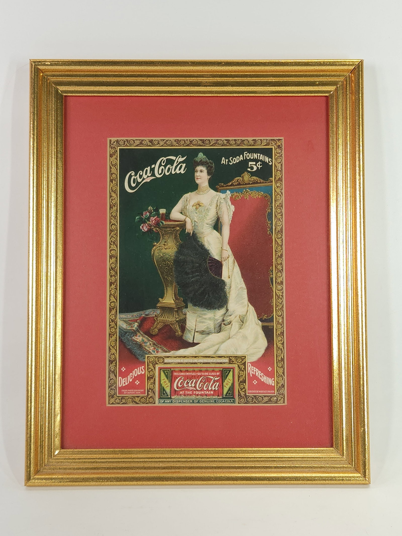 EARLY COCA COLA AT FOUNTAIN CARD REMOVAL SIGN: REMAINS IN VERY GOOD CONDITION, NICELY FRAMED.