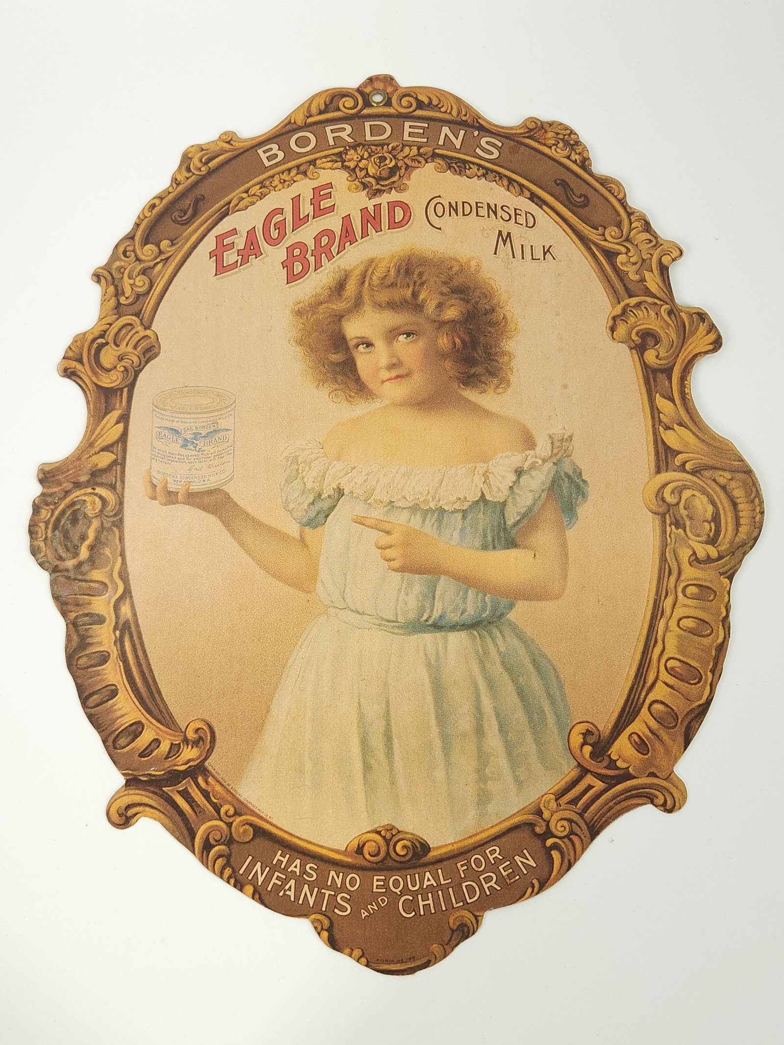 ANTIQUE EAGLE BRAND MILK ADVERTISING TRADE SIGN: REMAINS IN GOOD CONDITION, SHOWING ONLY SOME TYPICAL WEAR.