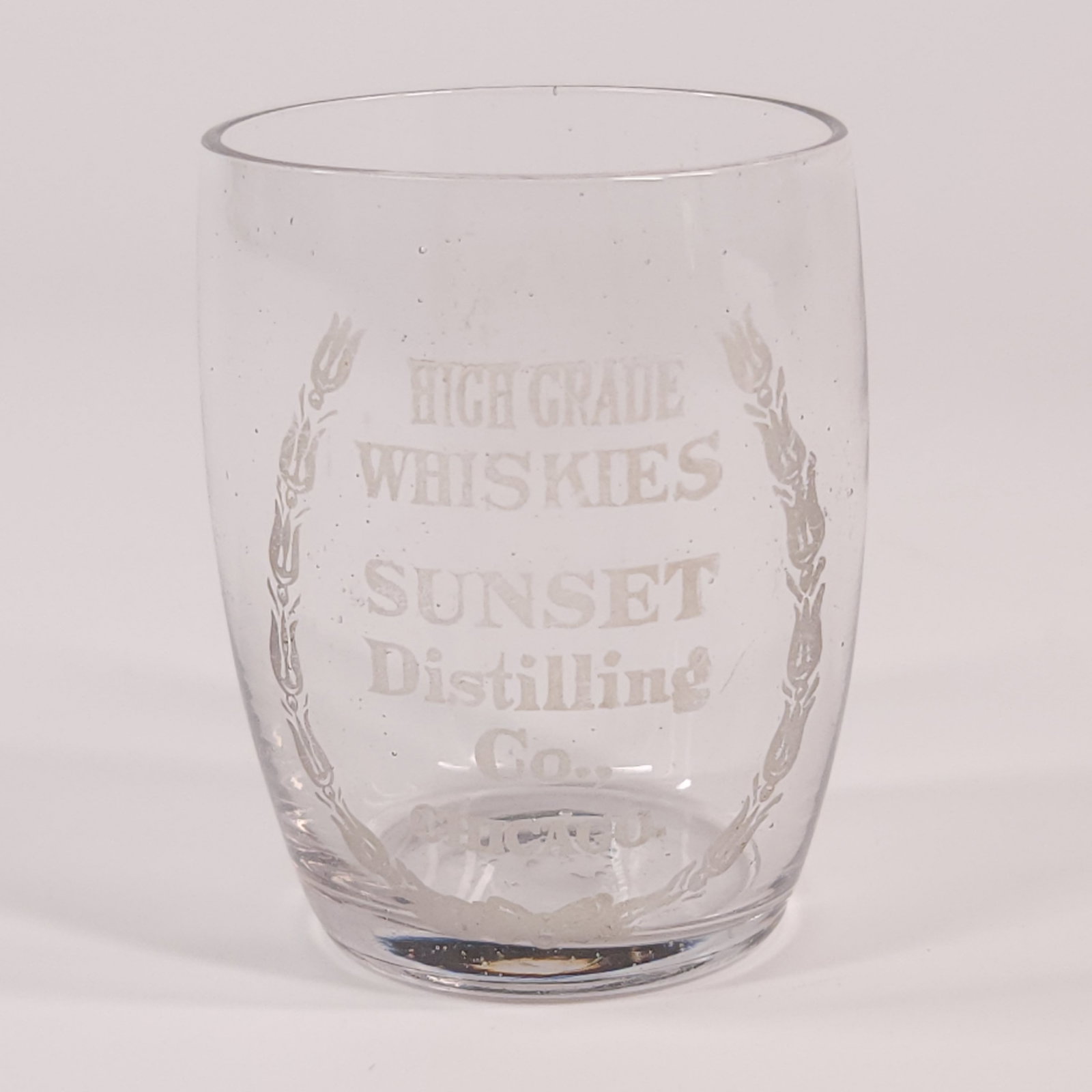 SUNSET DISTILLING CO. CHICAGO ADV. SHOT GLASS: REMAINS IN VERY GOOD CONDITION, NO CHIPS OR CRACKS.