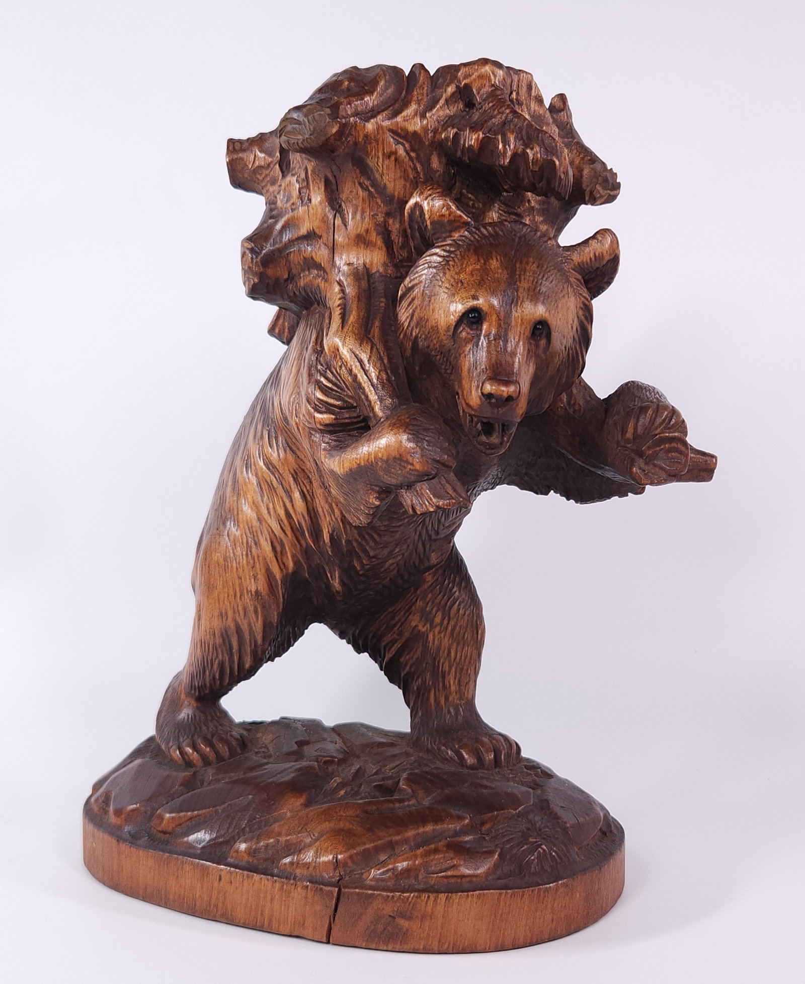 ANTIQUE BLACK FOREST WOOD CARVED BEAR CARRYING: REMAINS IN GOOD CONDITION, SHOWING SOME TYPICAL WEAR CONSISTENT WITH AGE AND USE.