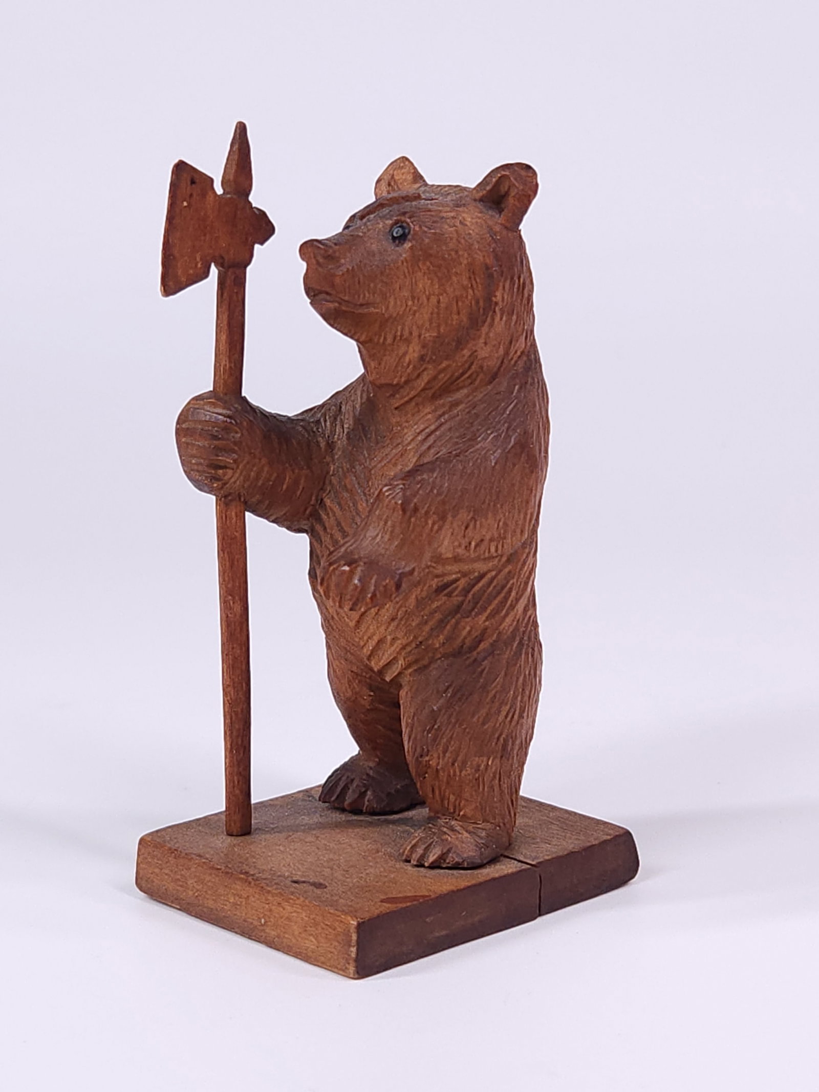 ANTIQUE BLACK FOREST CARVED KNIGHT BEAR FIGURINE: REMAINS IN GOOD CONDITION, SHOWING SOME TYPICAL WEAR CONSISTENT WITH USE AND AGE.