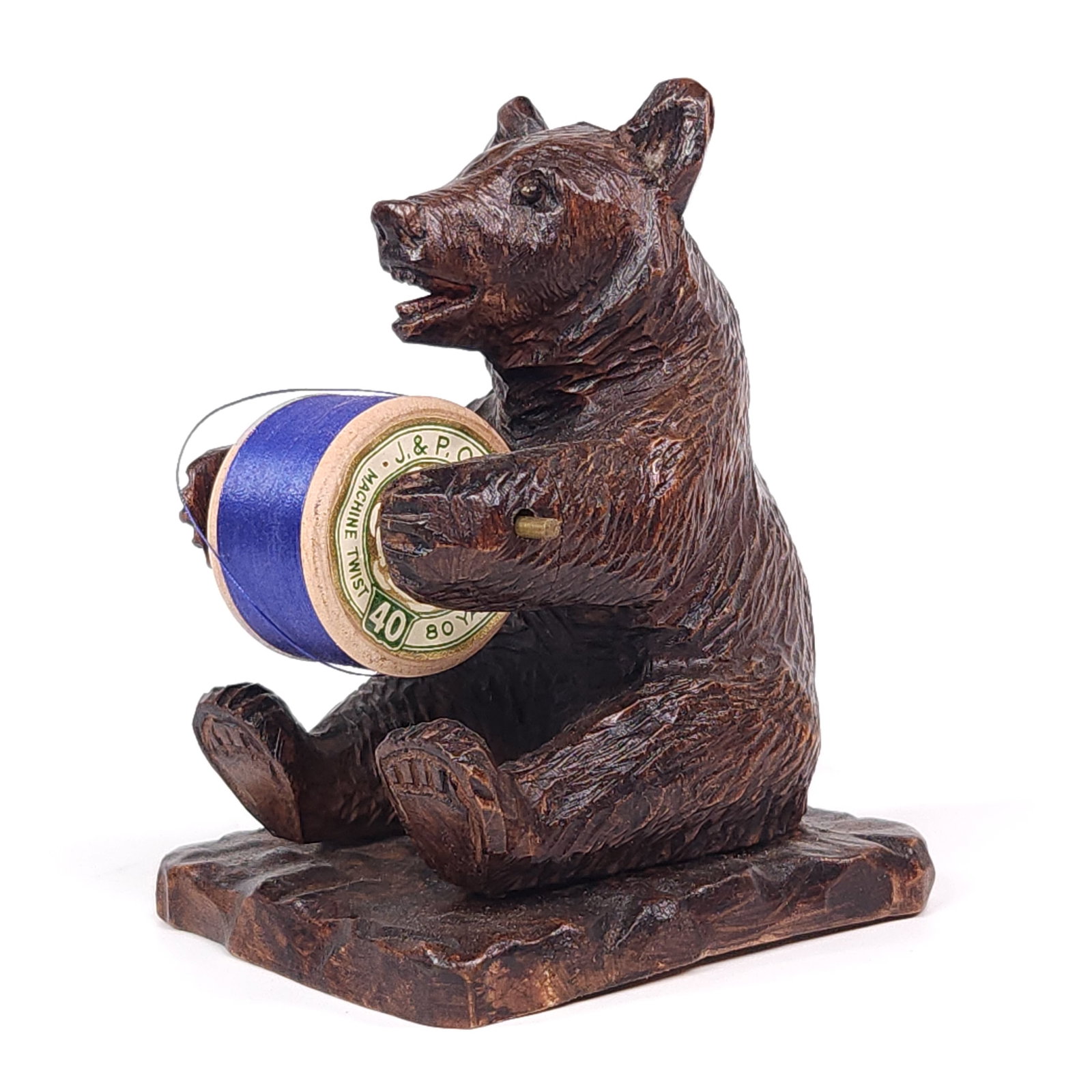 BLACK FOREST WOOD CARVED BEAR SEWING THREAD STAND: REMAINS IN GOOD CONDITION, SHOWING SOME TYPICAL WEAR. SMALL CRACK SHOWN ON LEFT ARM AT HAND.