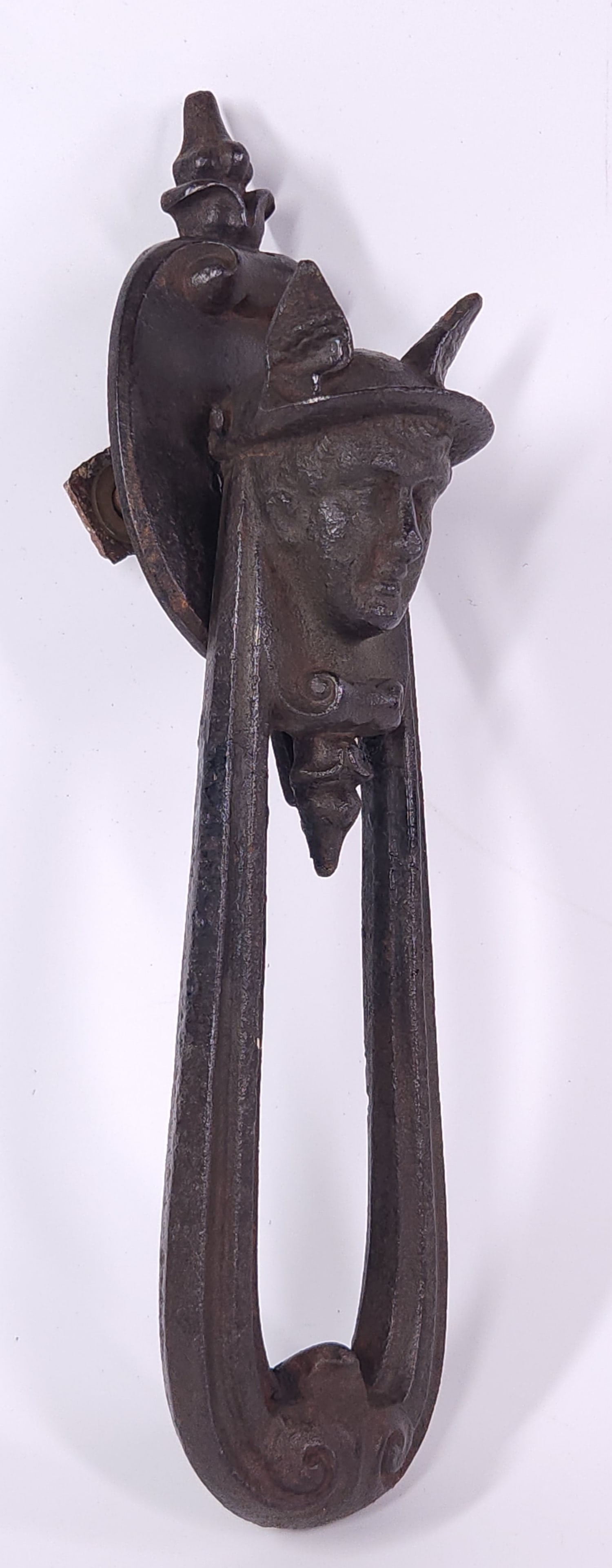 ANTIQUE CAST IRON HERMES WINGED HELMET DOOR KNOCKER: REMAINS IN FAIR TO GOOD CONDITION, SHOWING TYPICAL WEAR CONSISTENT WITH AGE AND USE.