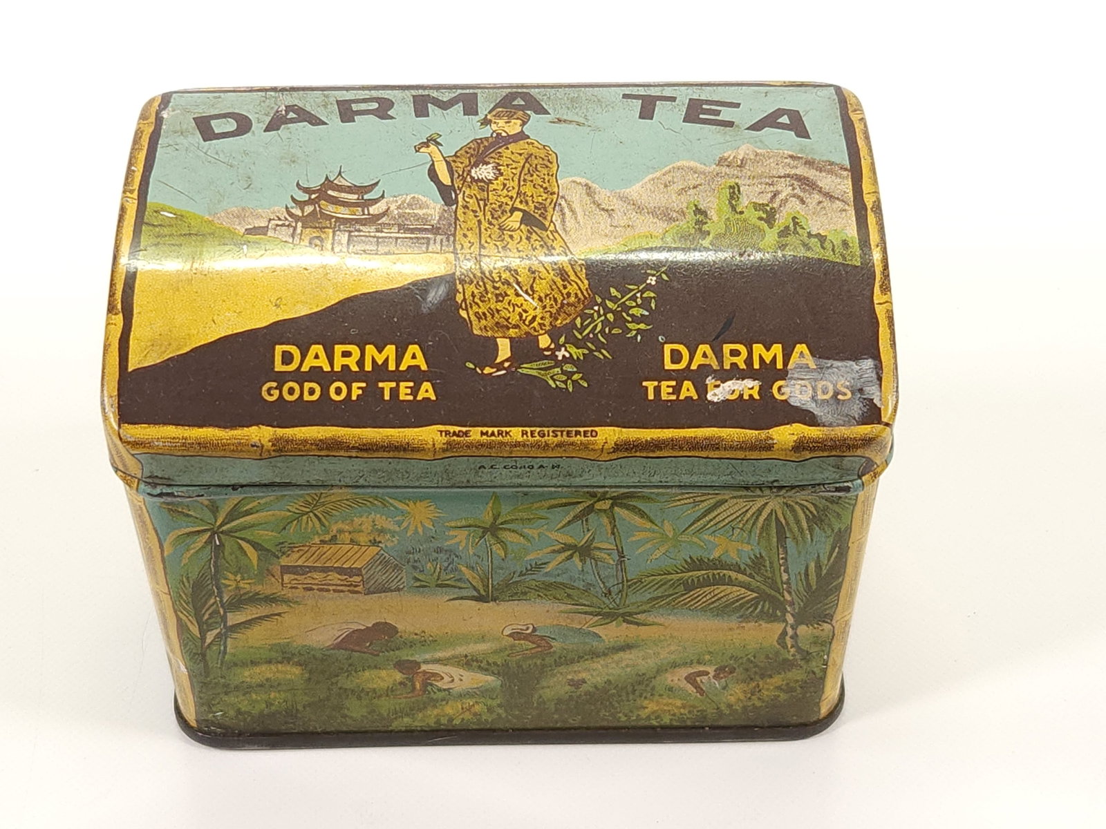DARMA TEA ADVERTISING TIN: REMAINS IN GOOD CONDITION, SHOWING TYPICAL WEAR.
