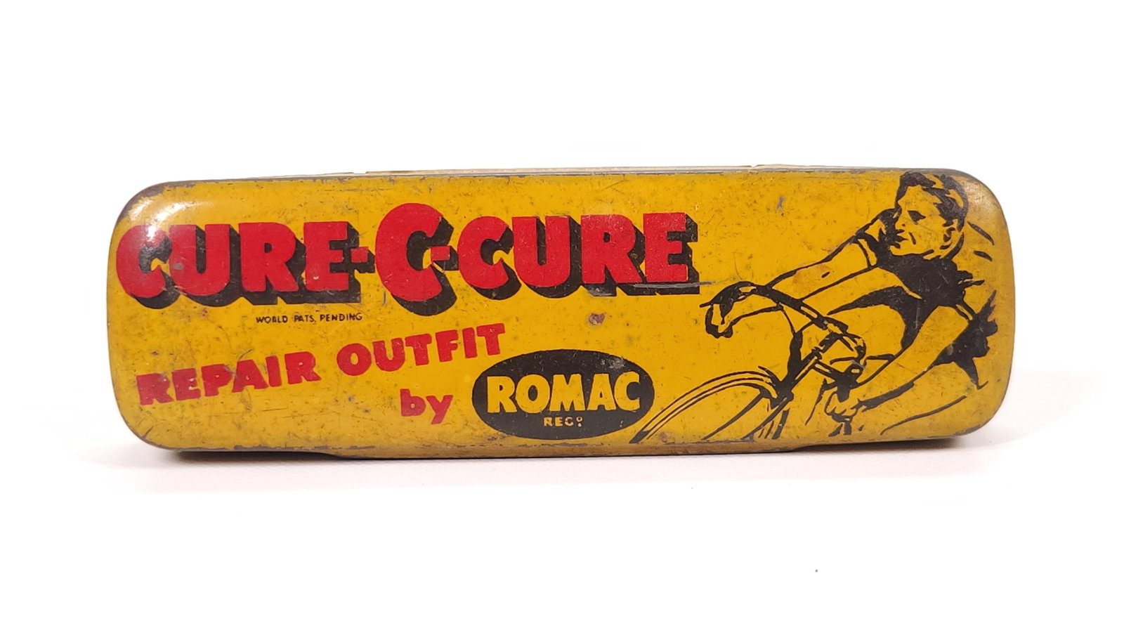 ROMAC CURE-C-CURE BIKE REPAIR OUTFIT TIN: REMAINS IN FAIR TO GOOD CONDITION, SHOWING SOME TYPICAL WEAR.