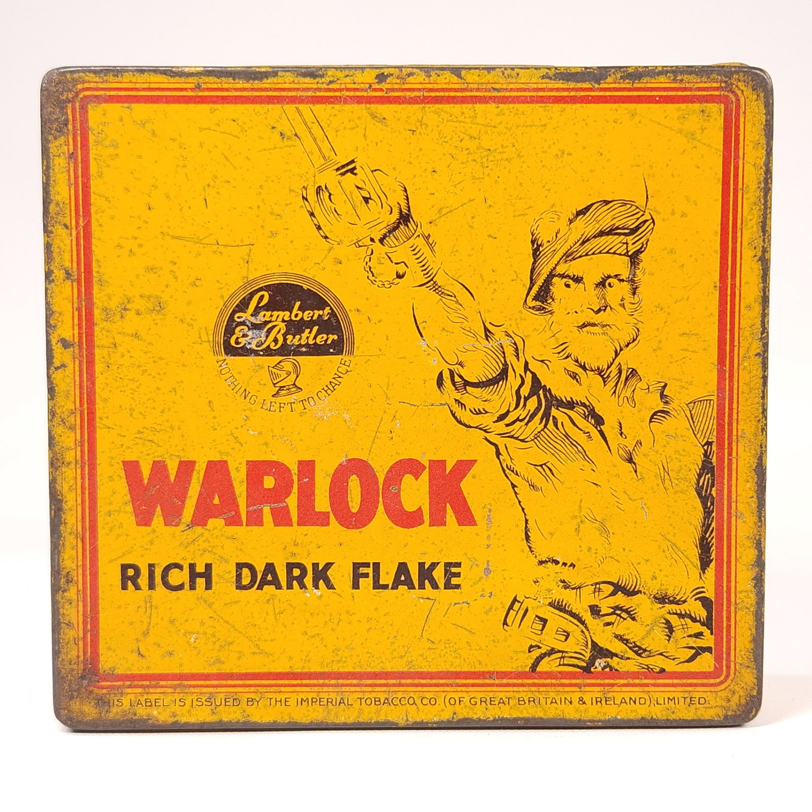 LAMBERT & BUTLER WARLOCK FLAKE TOBACCO TIN: REMAINS IN FAIR CONDITION, SHOWING WEAR THROUGHOUT.