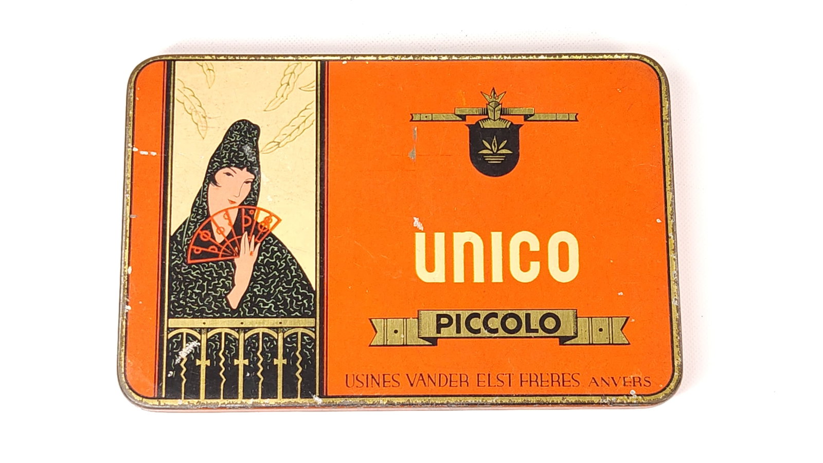 UNICO PICCOLO CIGARETTE TOBACCO TIN: REMAINS IN GOOD CONDITION, SHOWING SOME TYPICAL WEAR.