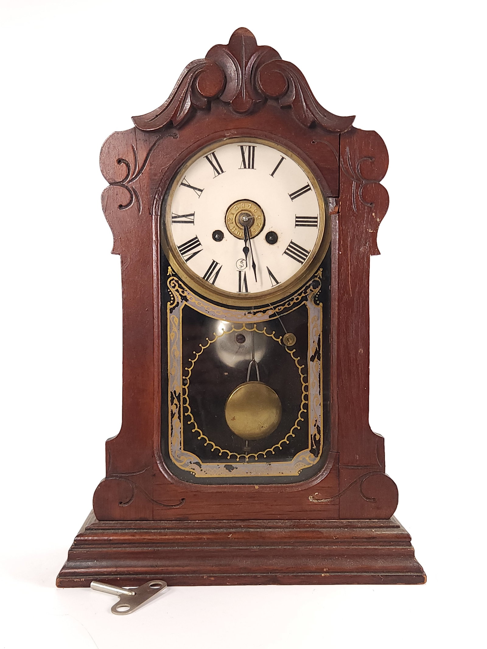 GINGERBREAD WOOD CASE MANTEL CLOCK EJ SWIGART FACE: CLOCK REMAINS IN GOOD CONDITION WITH LIGHT GENERAL WEAR, REPLACEMENT E.J. SWIGART FACE, INCLUDES PENDULUM & KEY APPROX. COMBINED DIMENSIONS: 16'' H x 11'' W x 5'' D