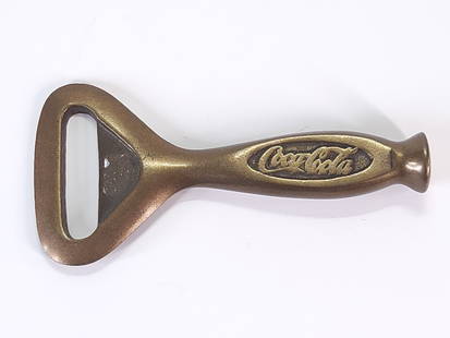 ANTIQUE BRASS COCA COLA BOTTLE OPENER: REMAINS IN GOOD CONDITION.