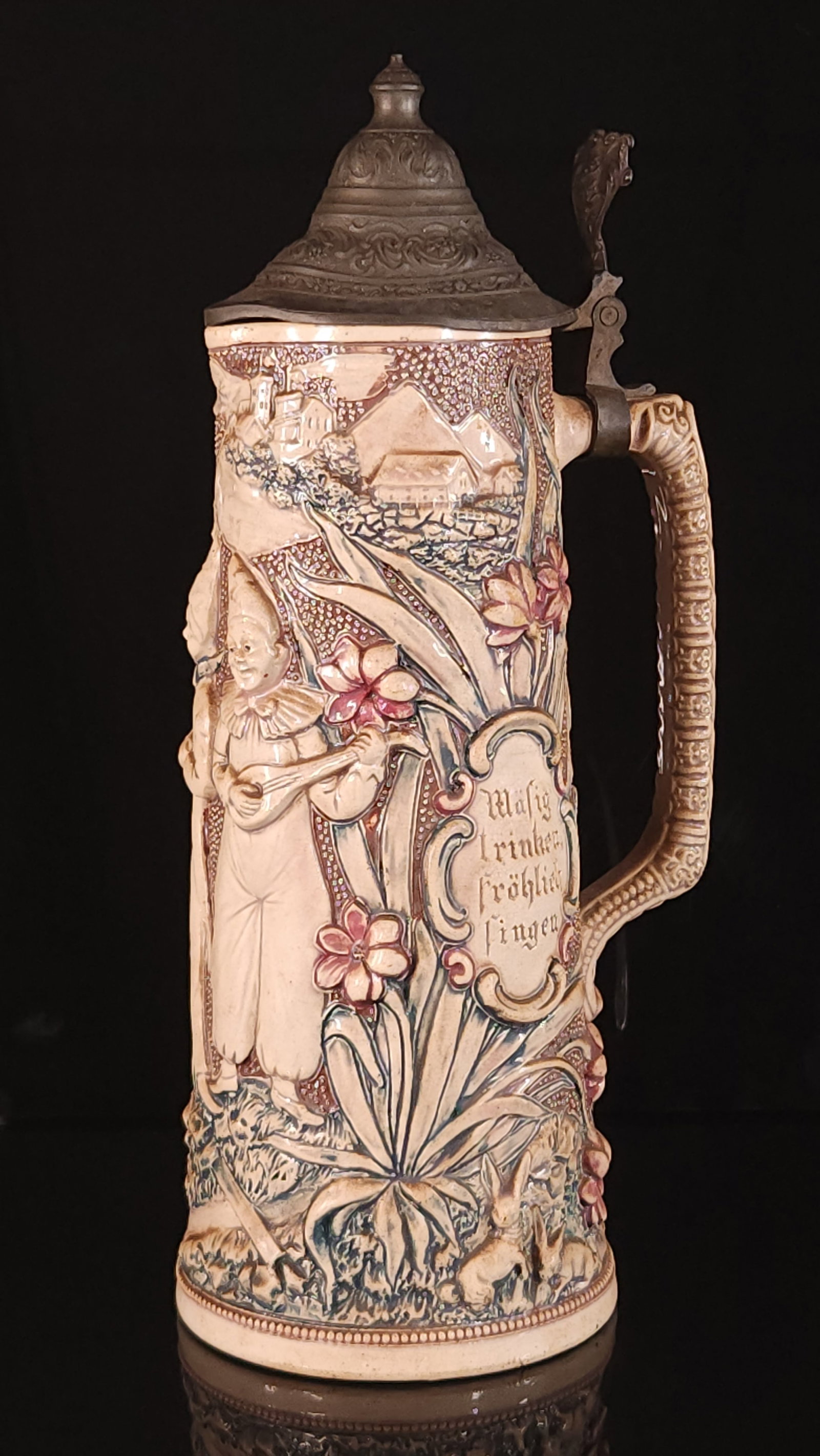 ANTIQUE GERMAN CLOWN JESTER W/ INSTRUMENTS STEIN: REMAINS IN GOOD CONDITION, SHOWING SOME TYPICAL WEAR. NO CHIPS OR CRACKS. NEEDS CLEANED. 13.5 INCHES TALL.